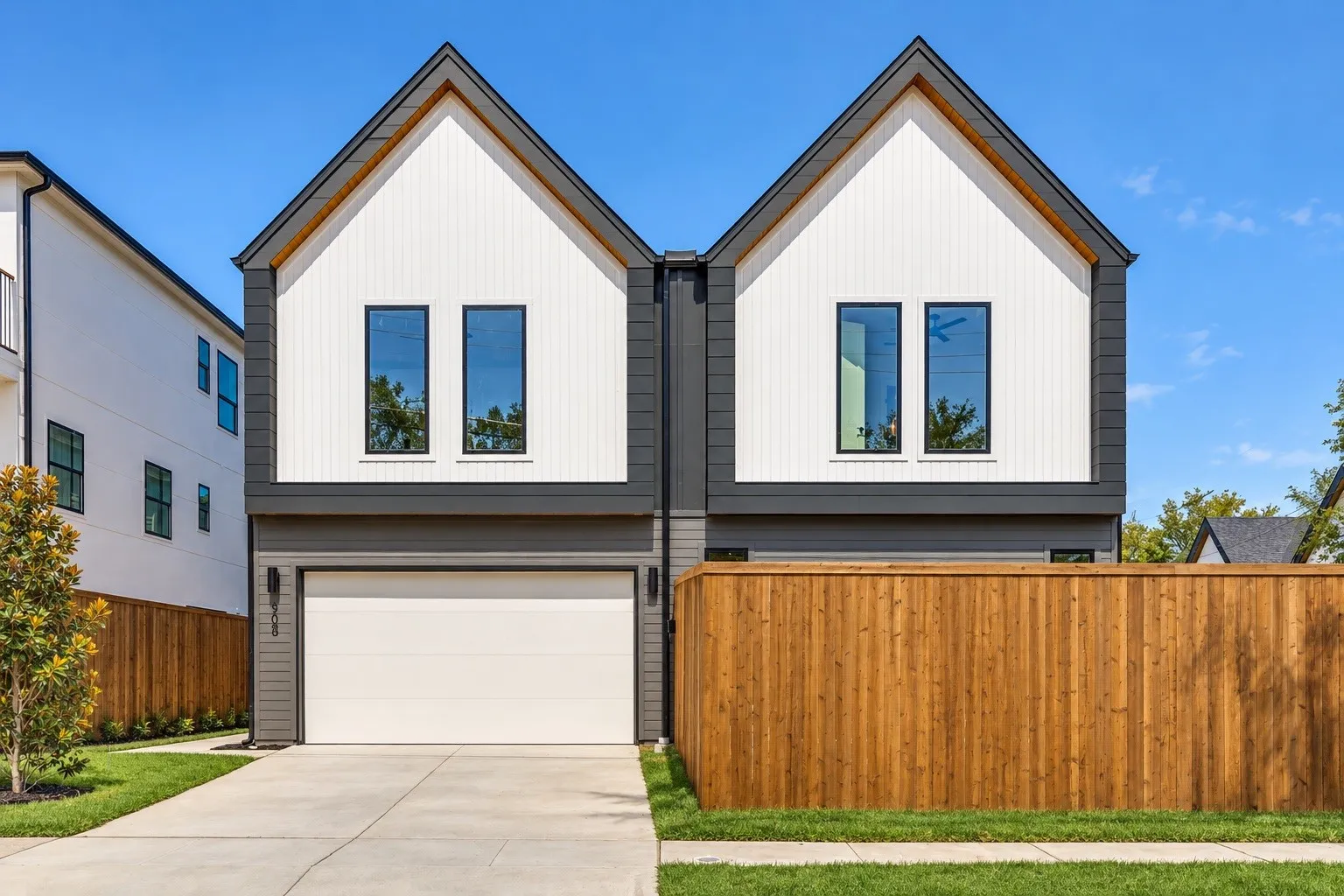 Contemporary facade featuring vertical white siding and dark gray horizontal siding