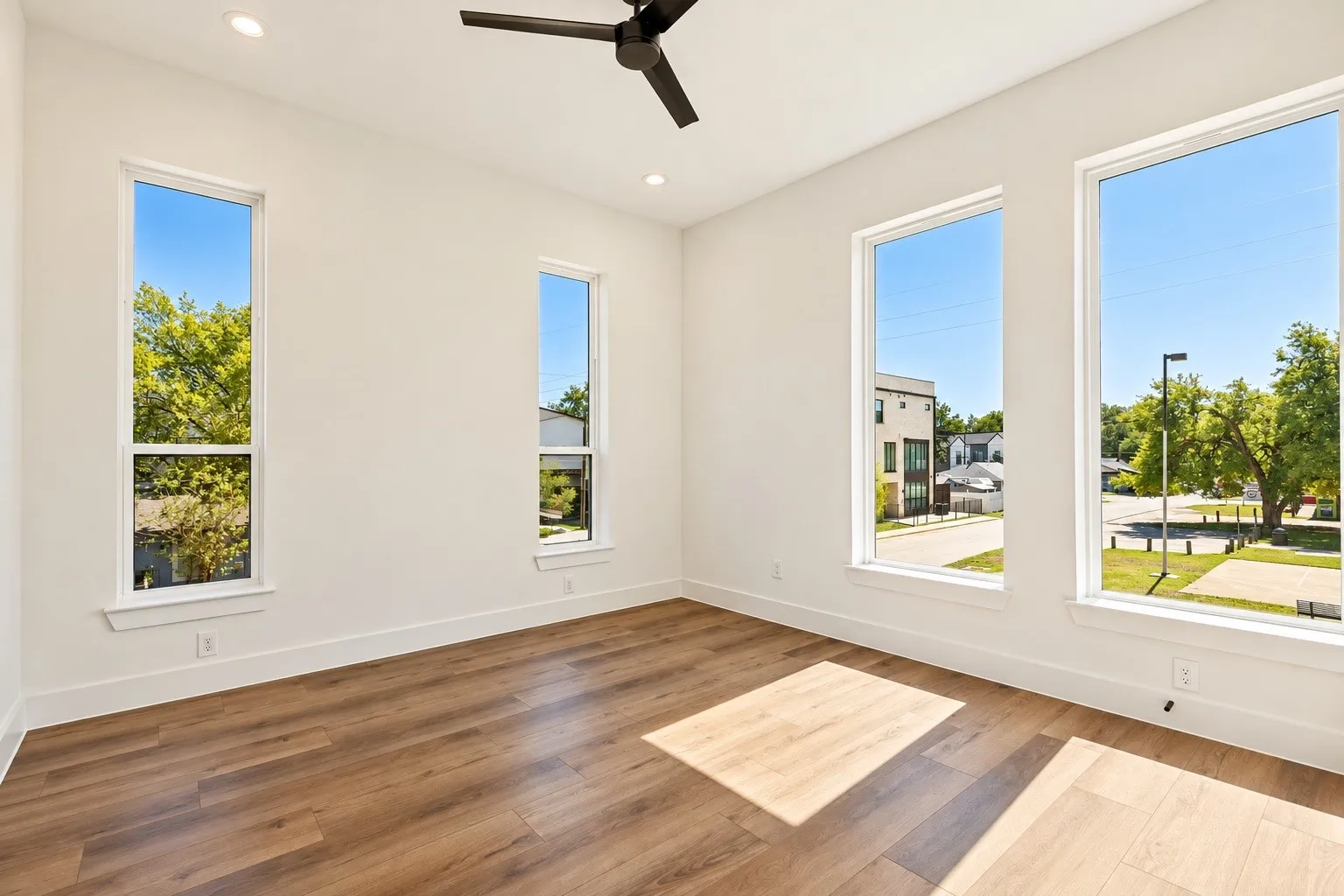 Recessed lighting, wood-finish flooring, and a ceiling fan