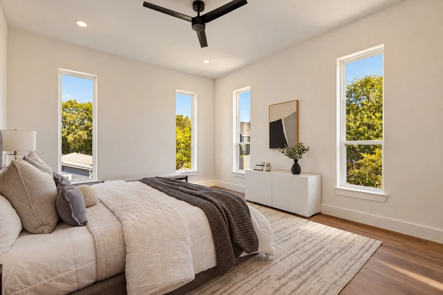 Wood-finish flooring, recessed lighting, and a contemporary ceiling fan