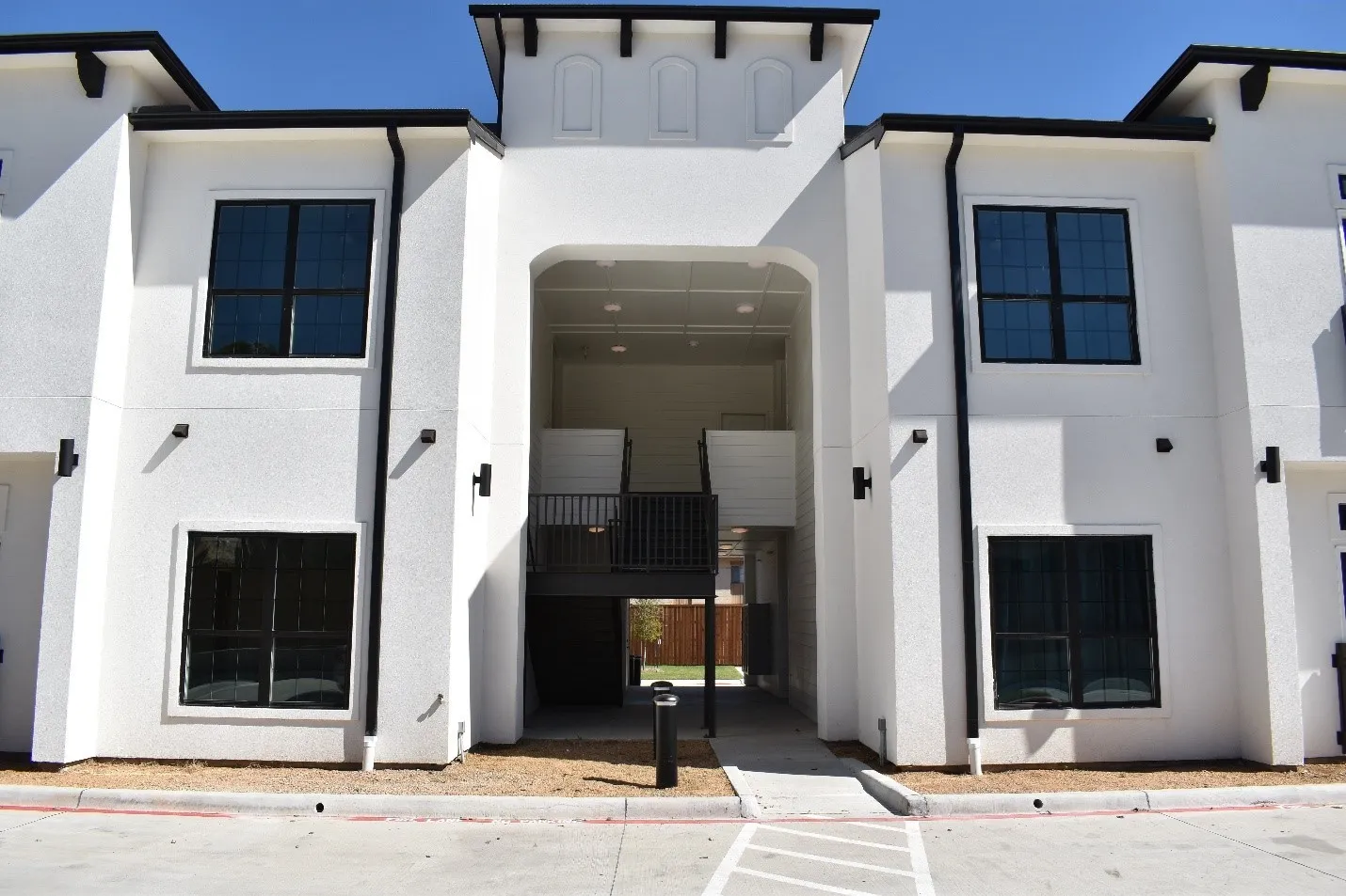 Contemporary white stucco exterior with black trim accents
