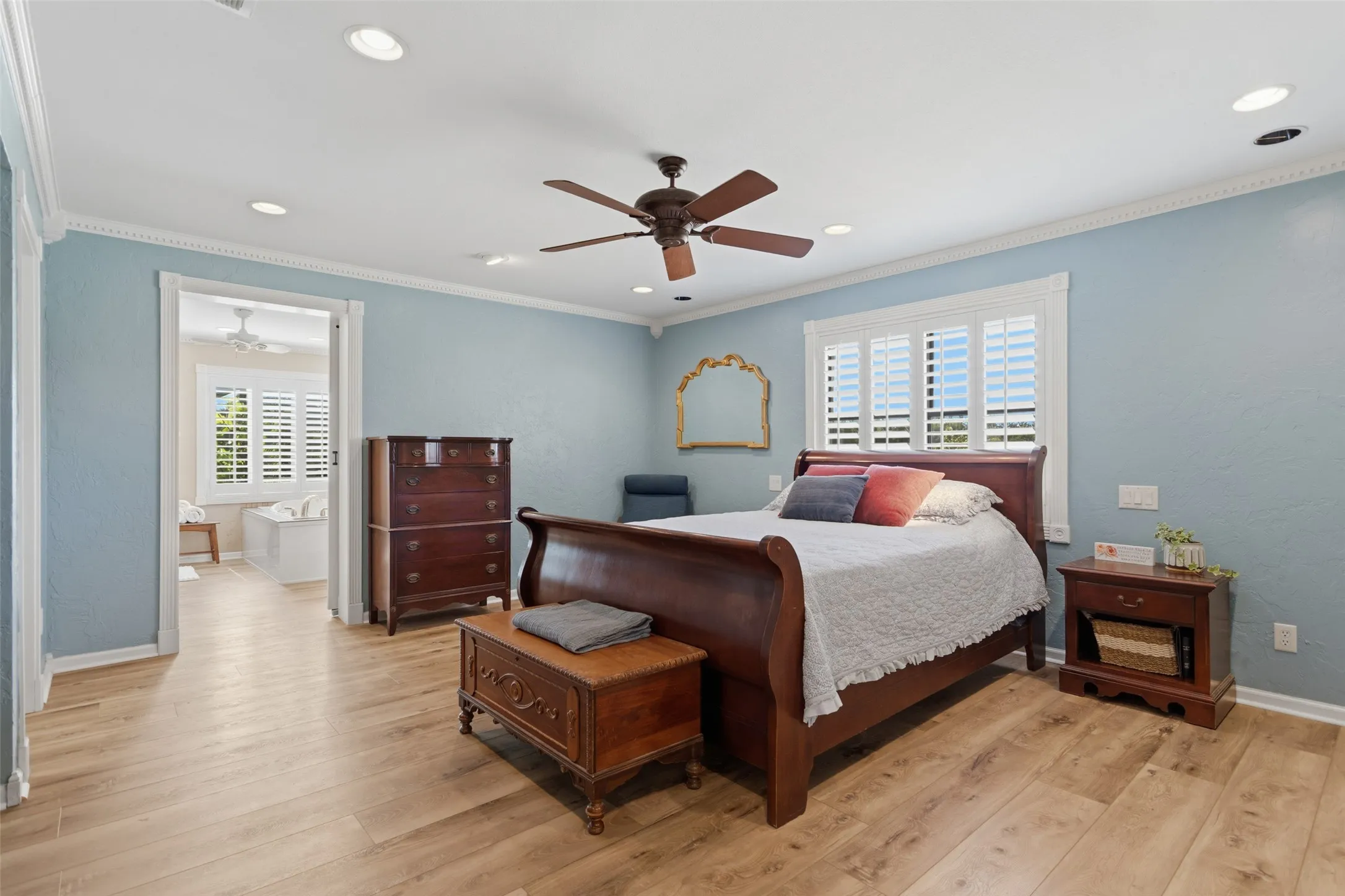 Recessed lighting, wood-finish flooring, ceiling fan, crown molding, and plantation shutters