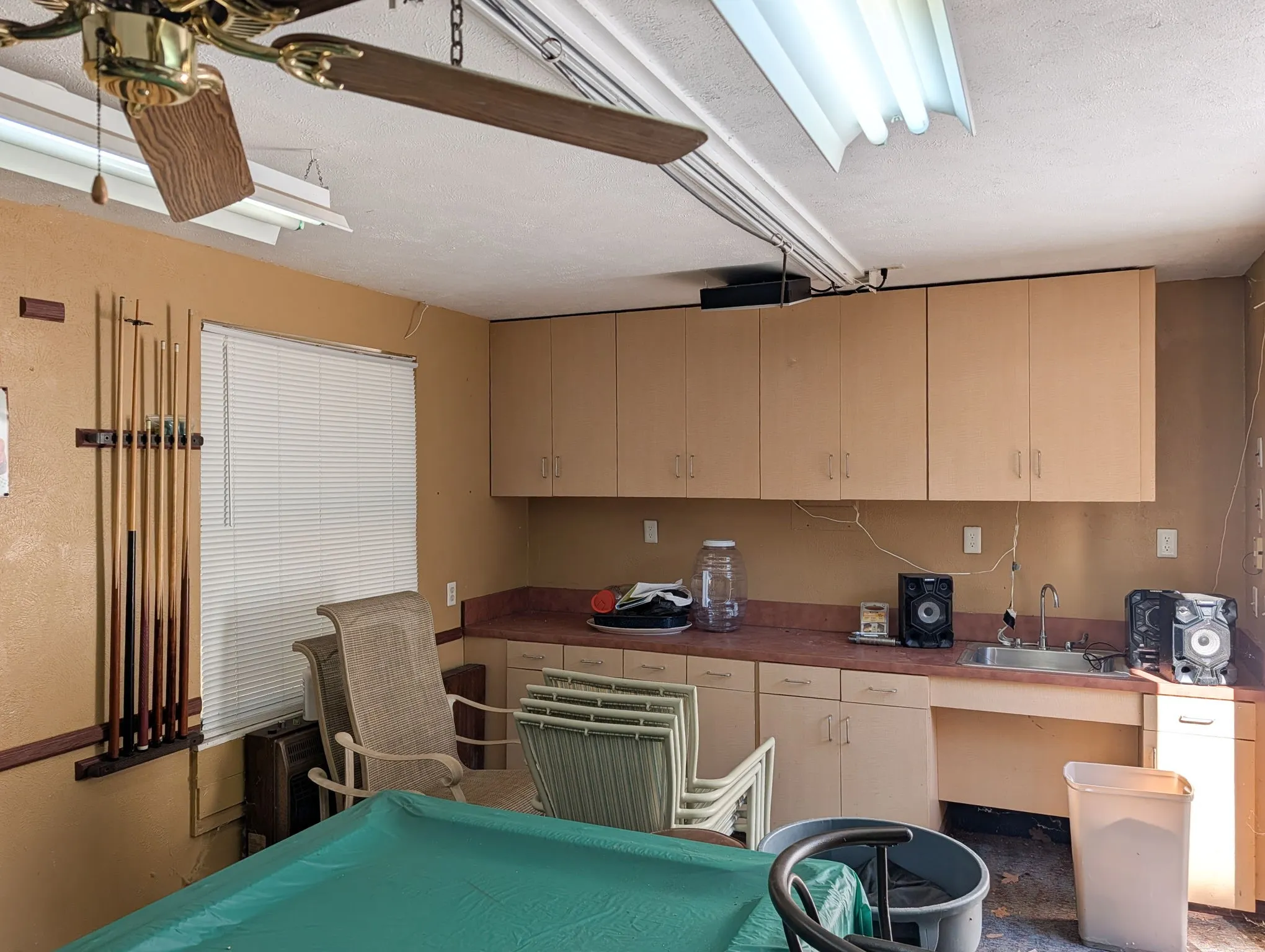 Built in cabinets and sink in gam-room
