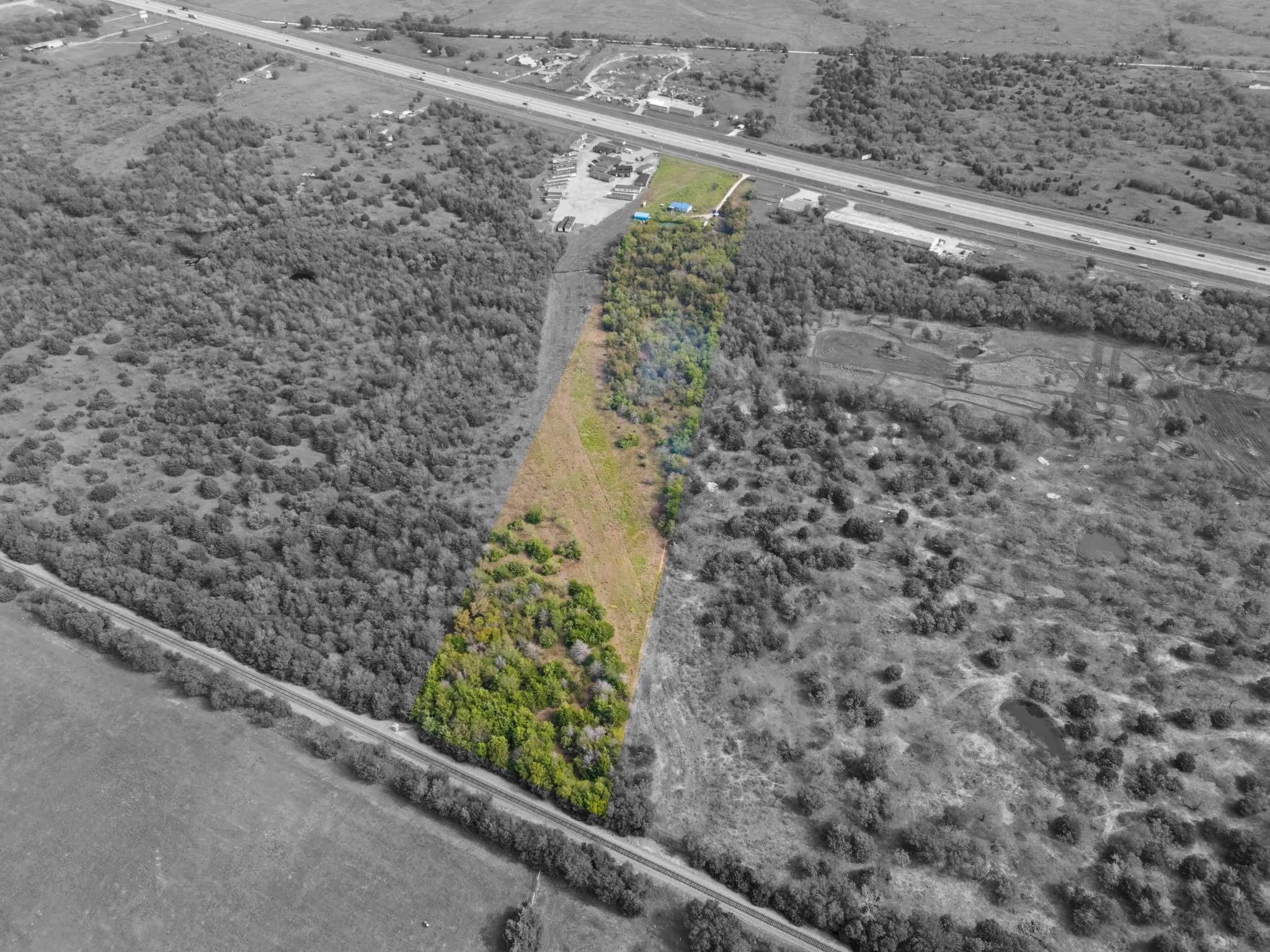Expansive land parcel featuring substantial tree coverage and cleared areas