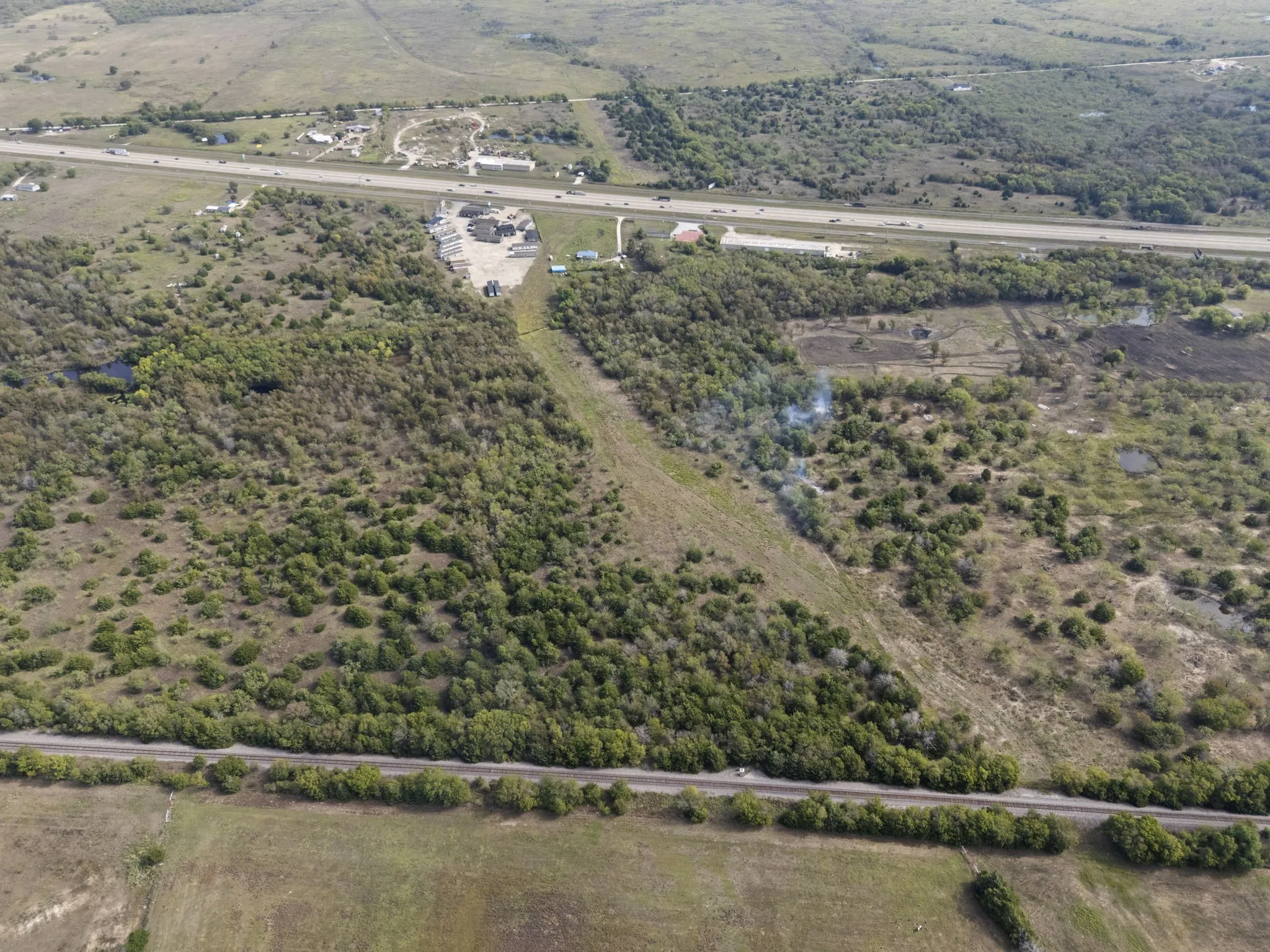 Expansive land parcel featuring natural tree coverage and open fields