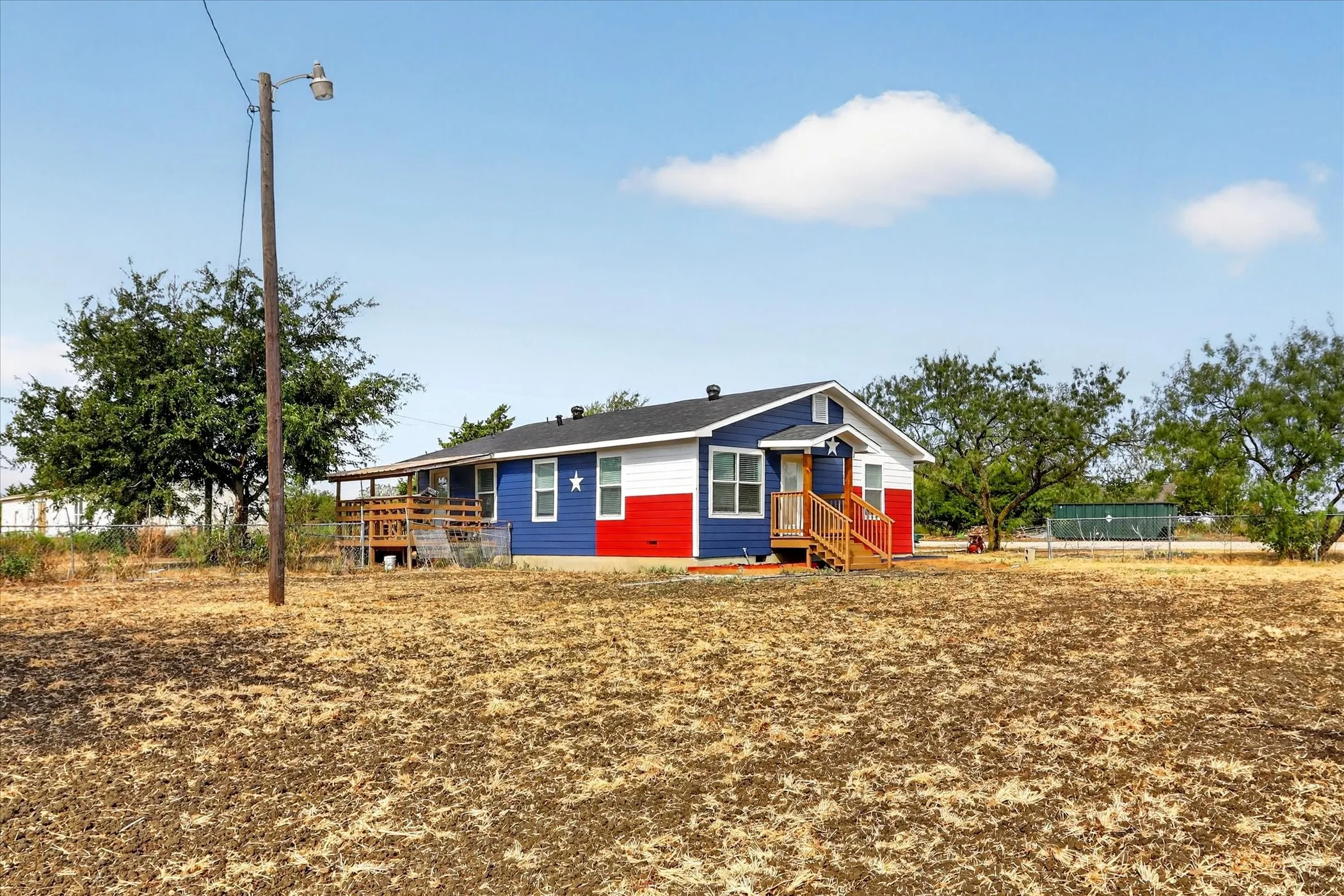 Single-story residence featuring a distinctive red, white, and blue exterior