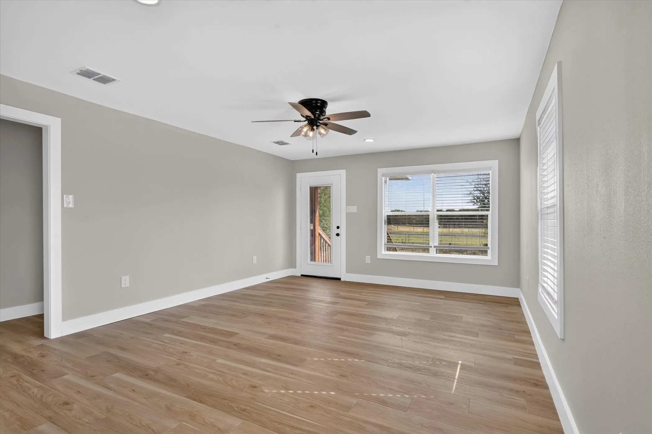 Wood-finish flooring, recessed lighting, and a ceiling fan with light