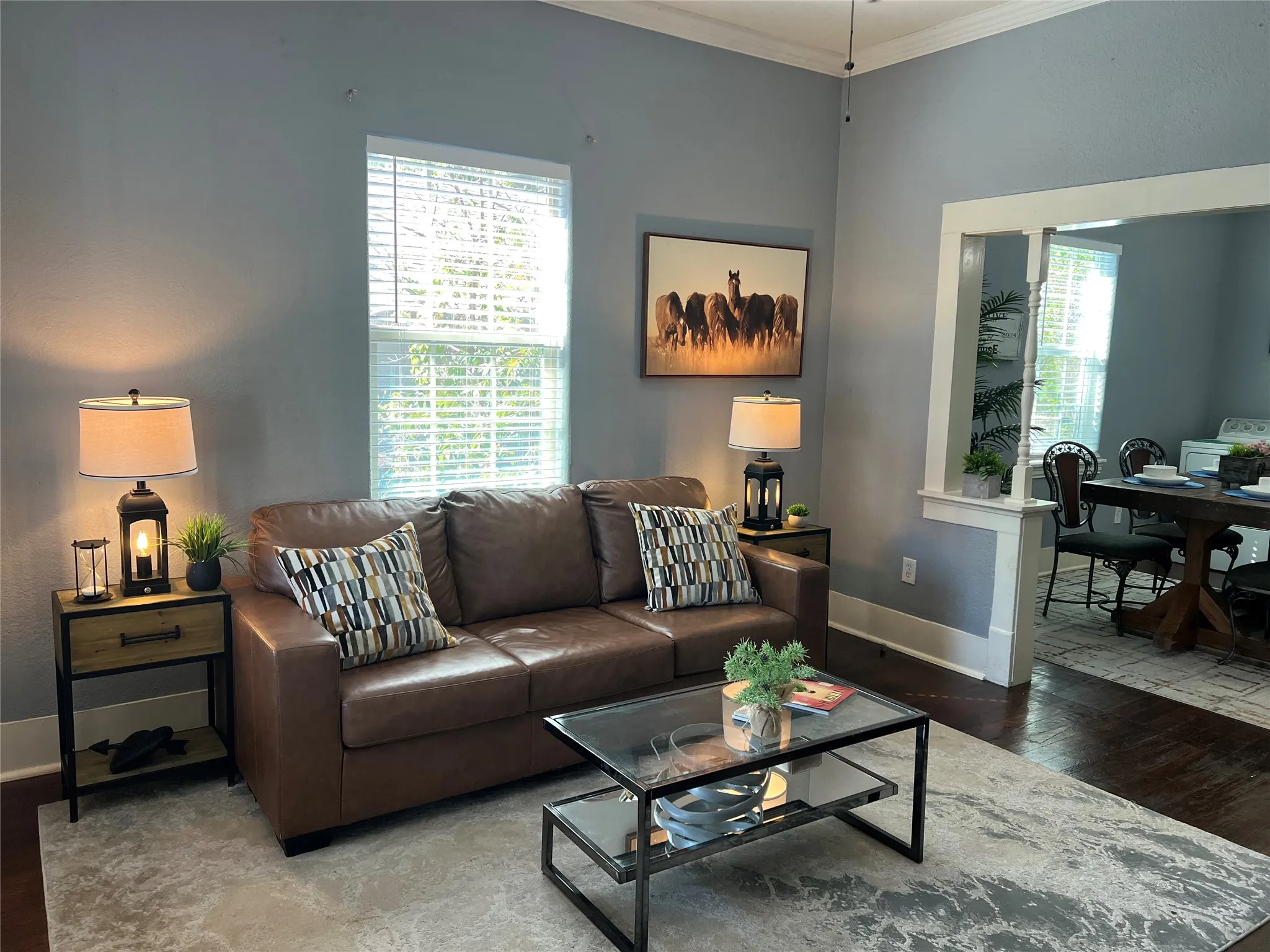 Archway opening, crown molding, cased windows, wood-finish flooring, and high ceilings