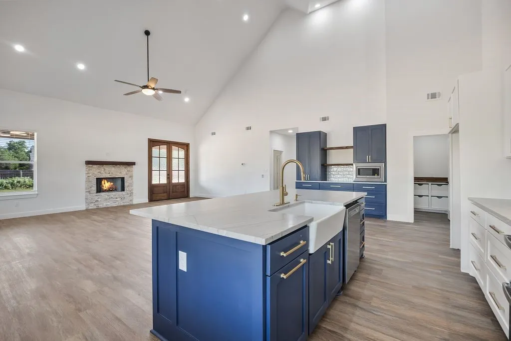 Large island with farmhouse sink and gold fixtures