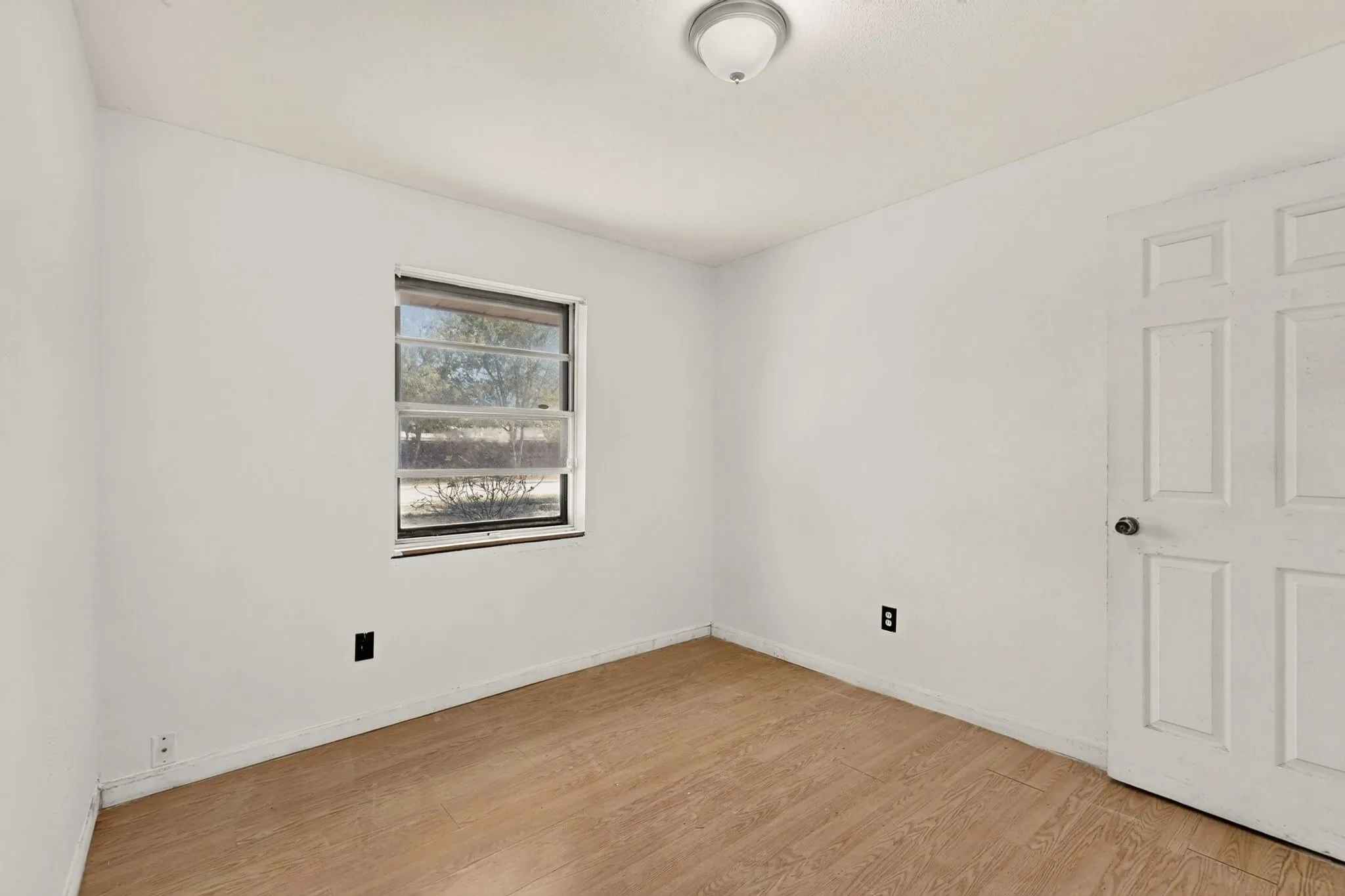 Neutral wall color with wood-finish flooring