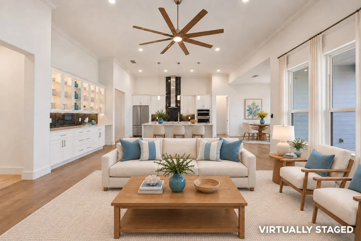 Virtually staged open floor plan living room, kitchen and dining room.