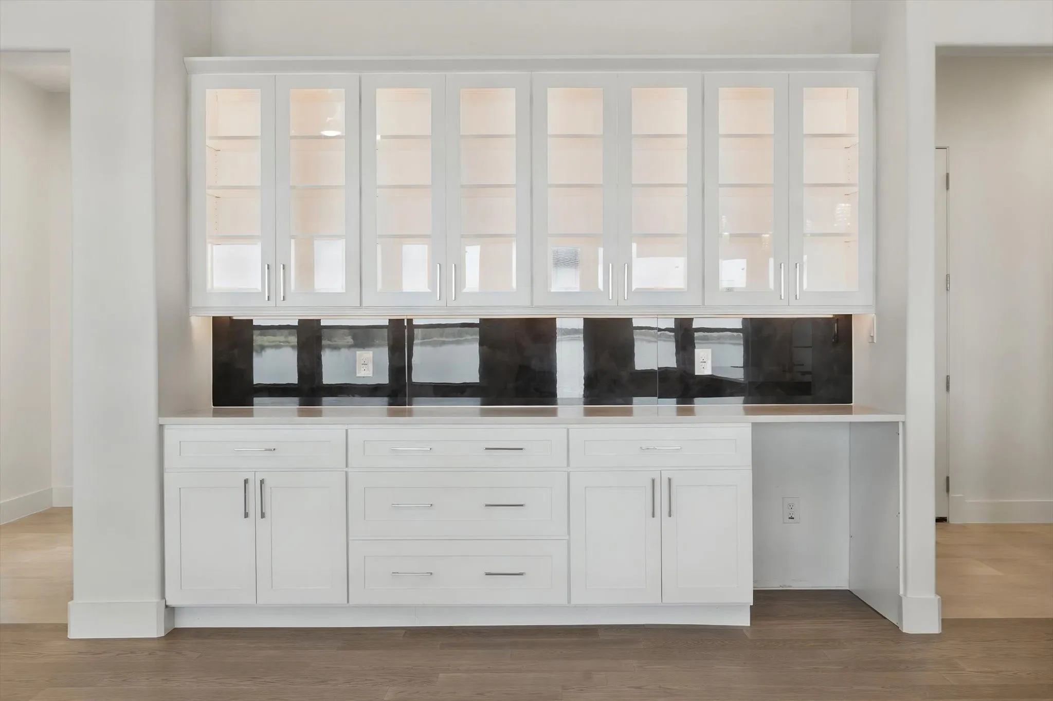 Custom built-in buffet and server station featuring soft internal cabinet lighting and under-mount drawer storage.