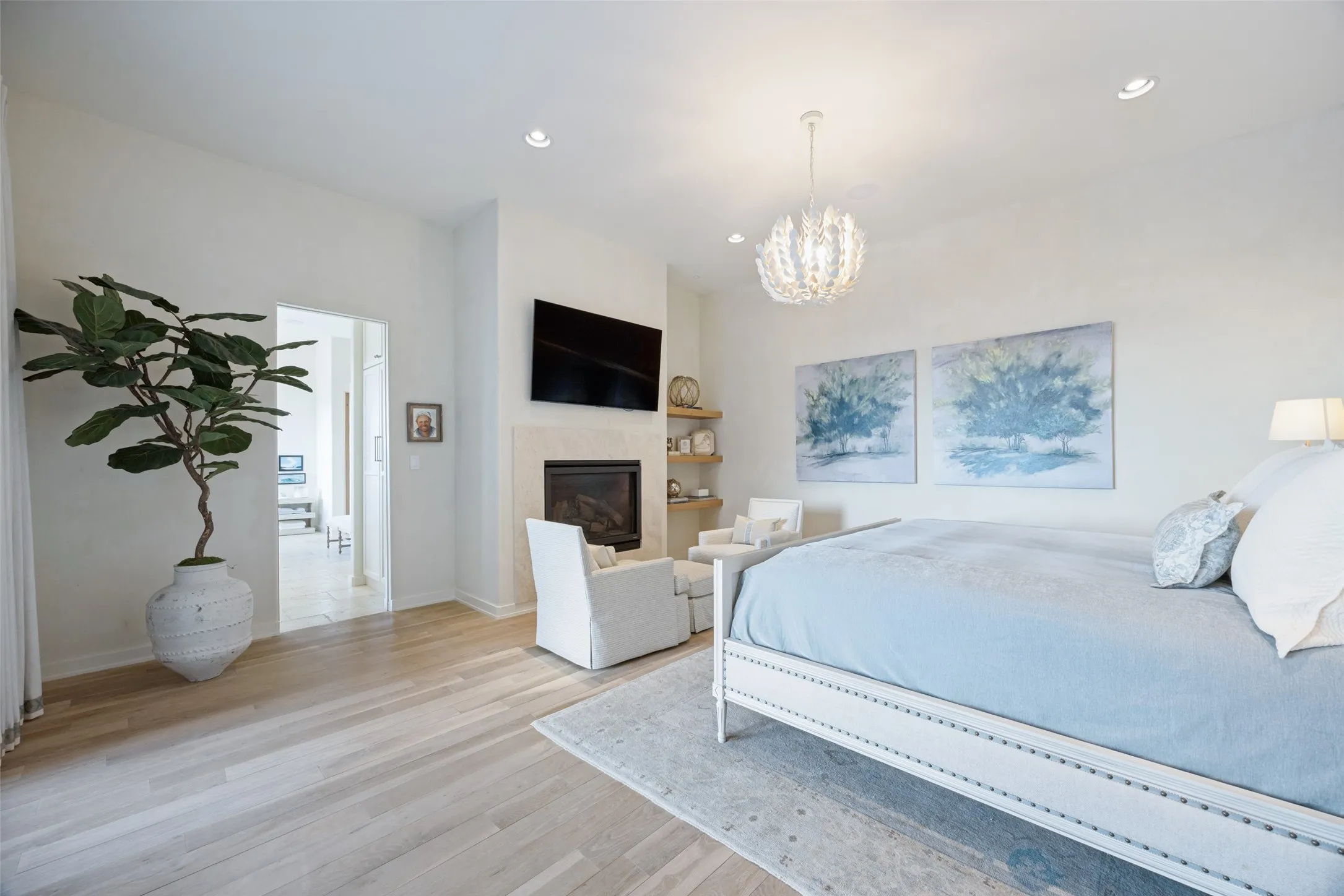 Recessed lighting, wood-finish flooring, fireplace, built-in shelving, and a decorative chandelier