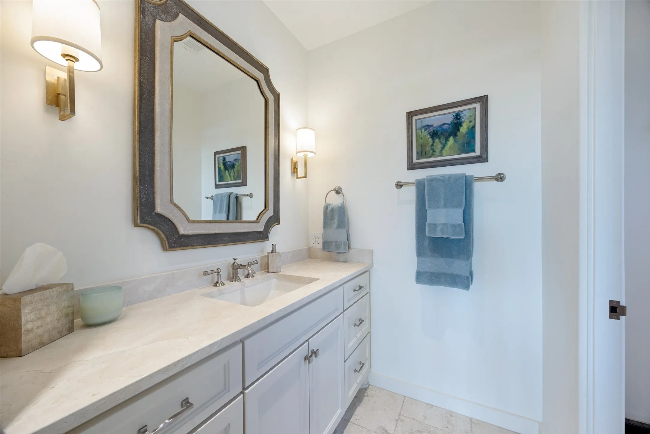 Vanity with integrated sink, light-toned countertop, and undermount cabinetry