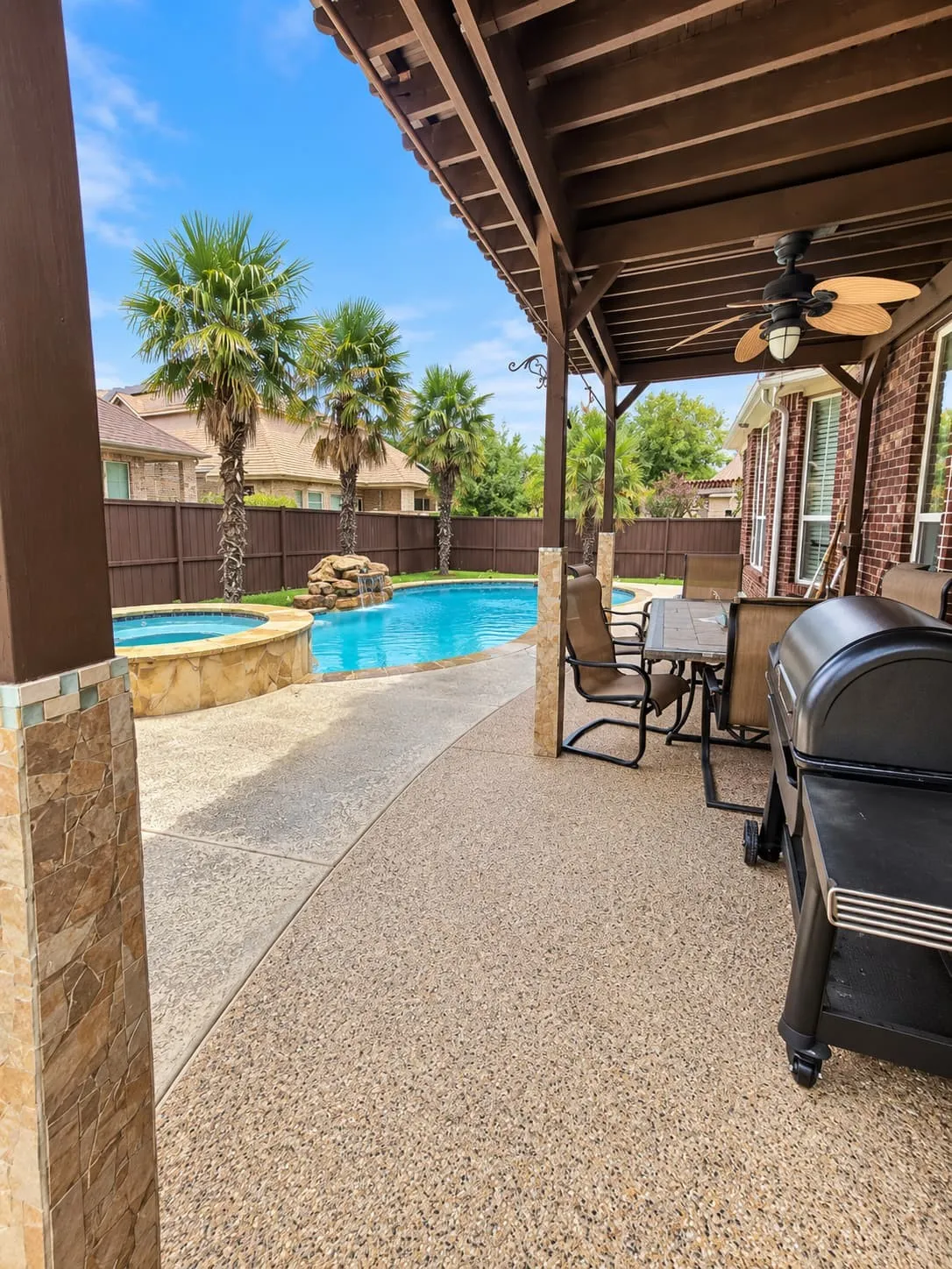 Covered patio featuring a wood ceiling and ceiling fan