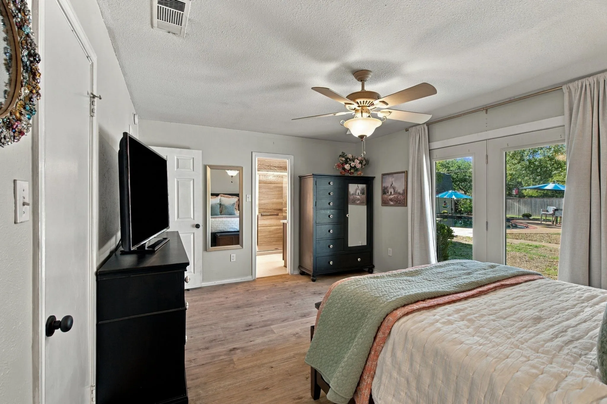 Primary bedroom with walk-out to pool.