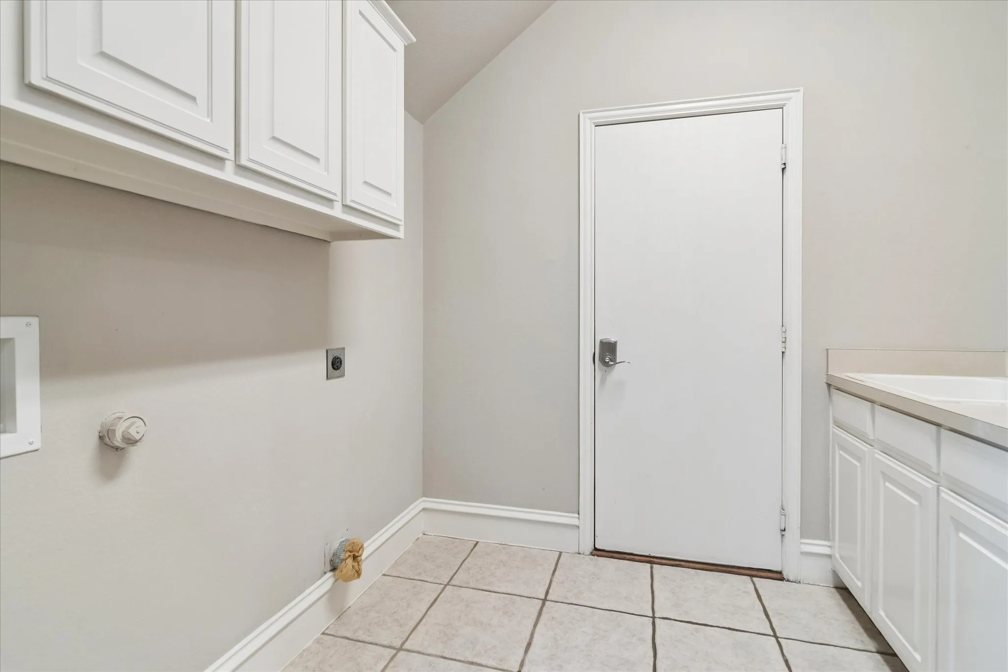 Tile flooring, built-in upper cabinetry, built-in lower cabinetry, solid surface countertop, utility connections
