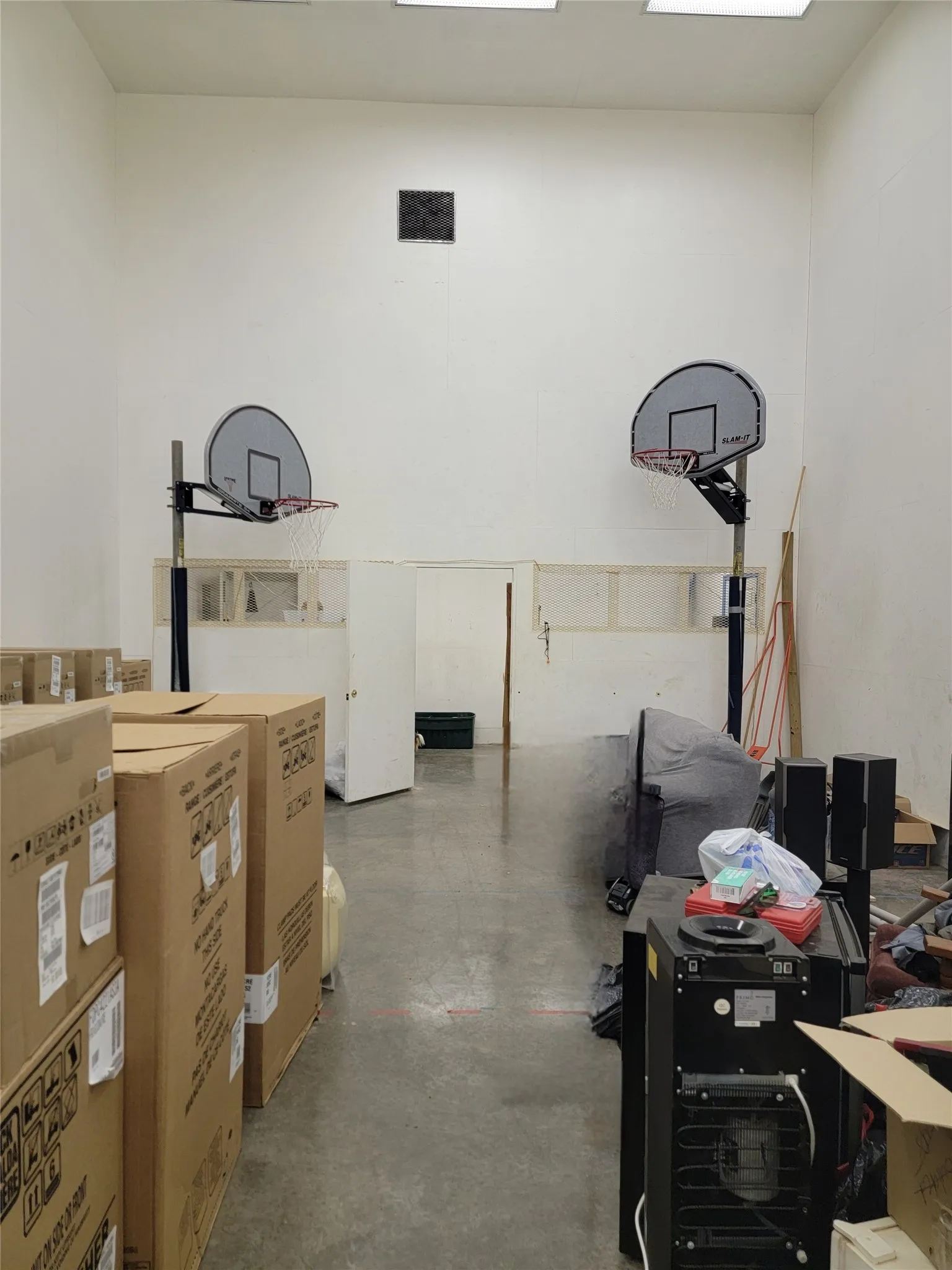 Racquet ball court and basketball goals