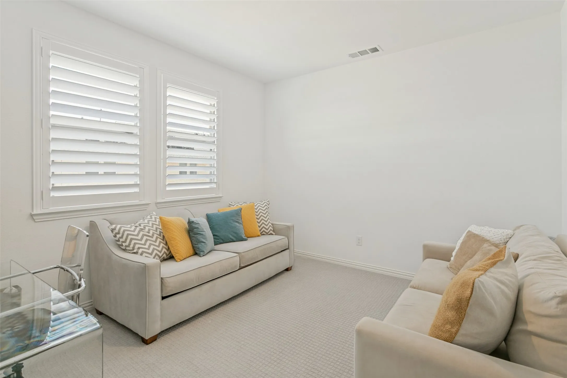 Dual windows with white plantation shutters