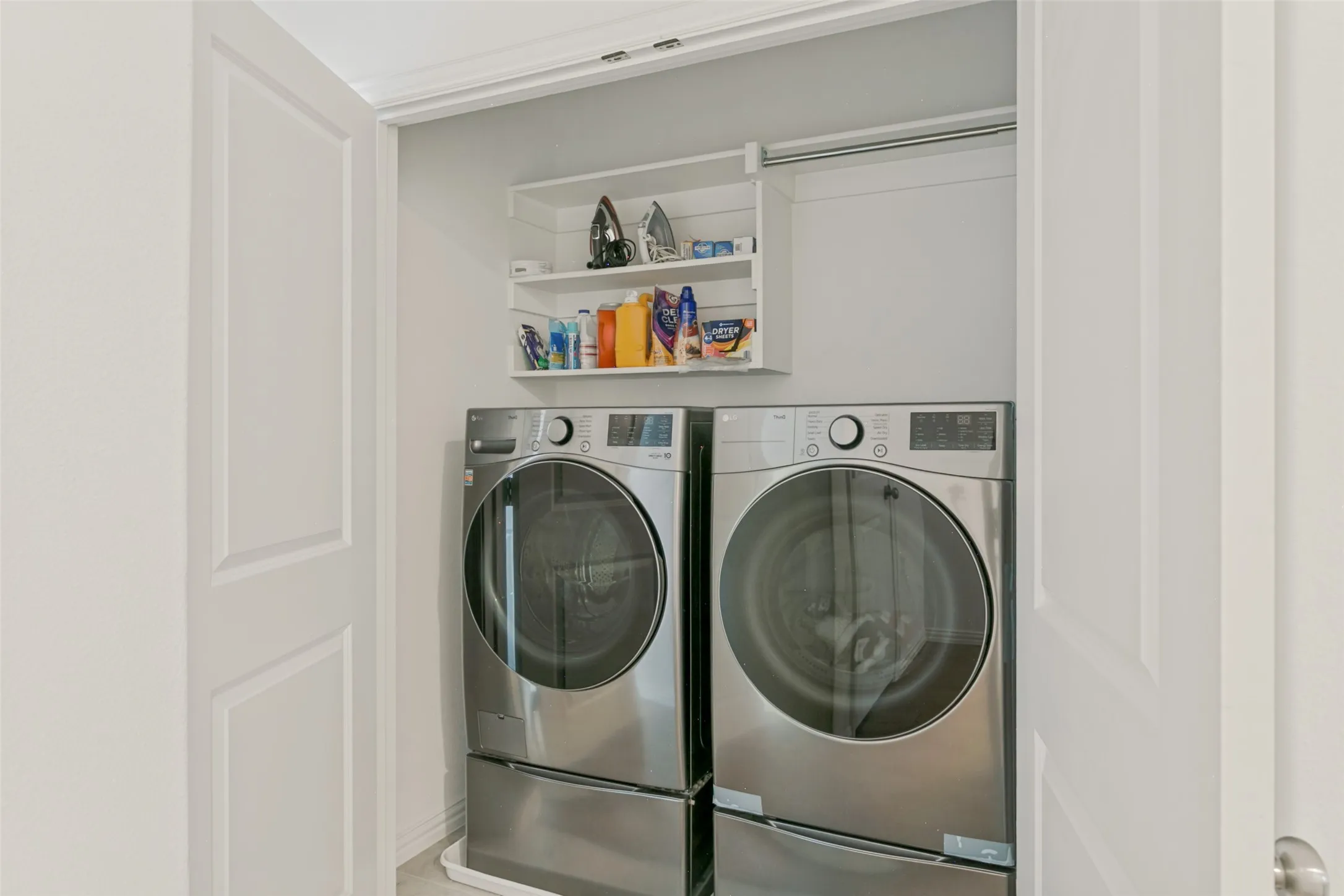 Built-in laundry closet with dual stainless steel front-load machines