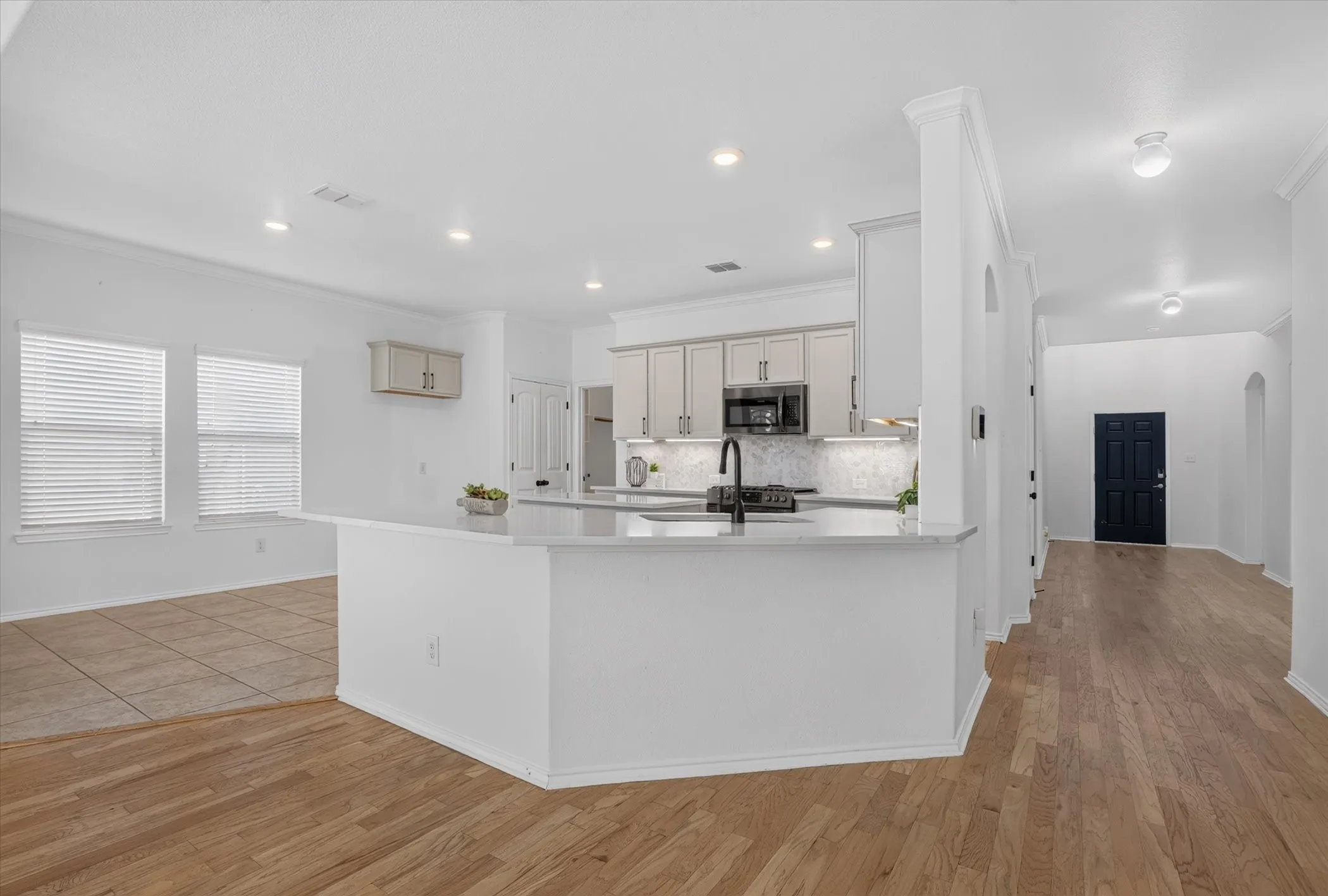 Kitchen with white cabinetry, stainless steel appliances, and a light-colored countertop
