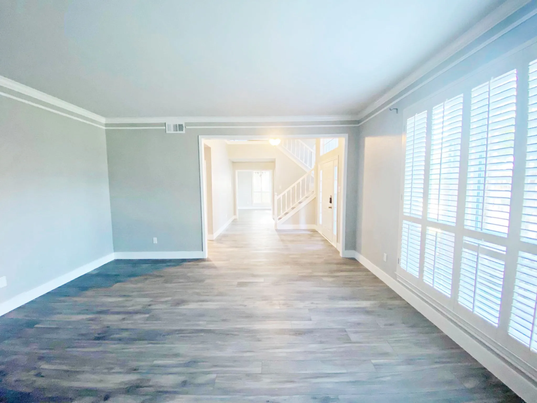Spare room with hardwood / wood-style flooring and ornamental molding