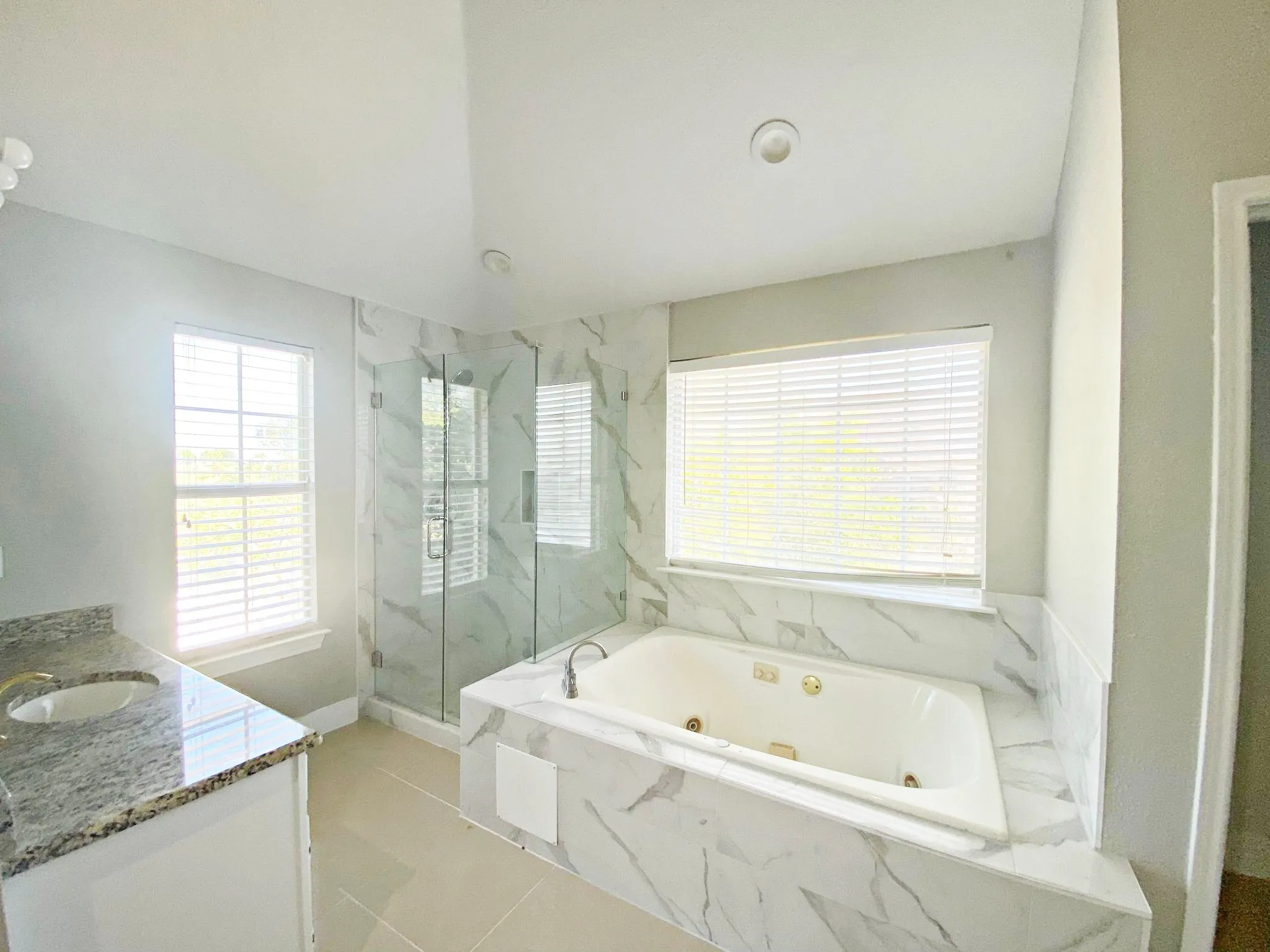 Bathroom with tile flooring, vanity, and plus walk in shower