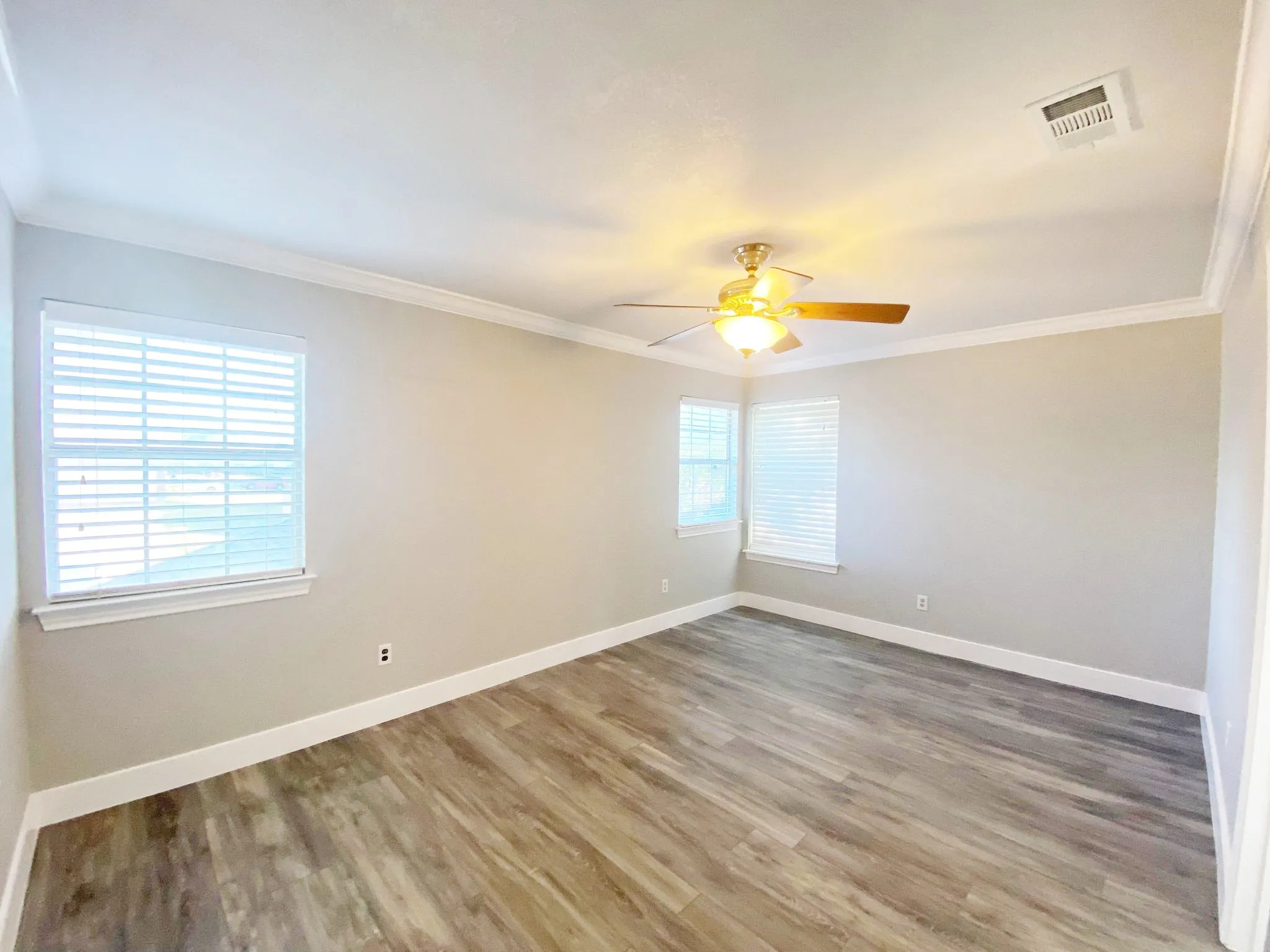 flooring, ceiling fan, and ornamental molding