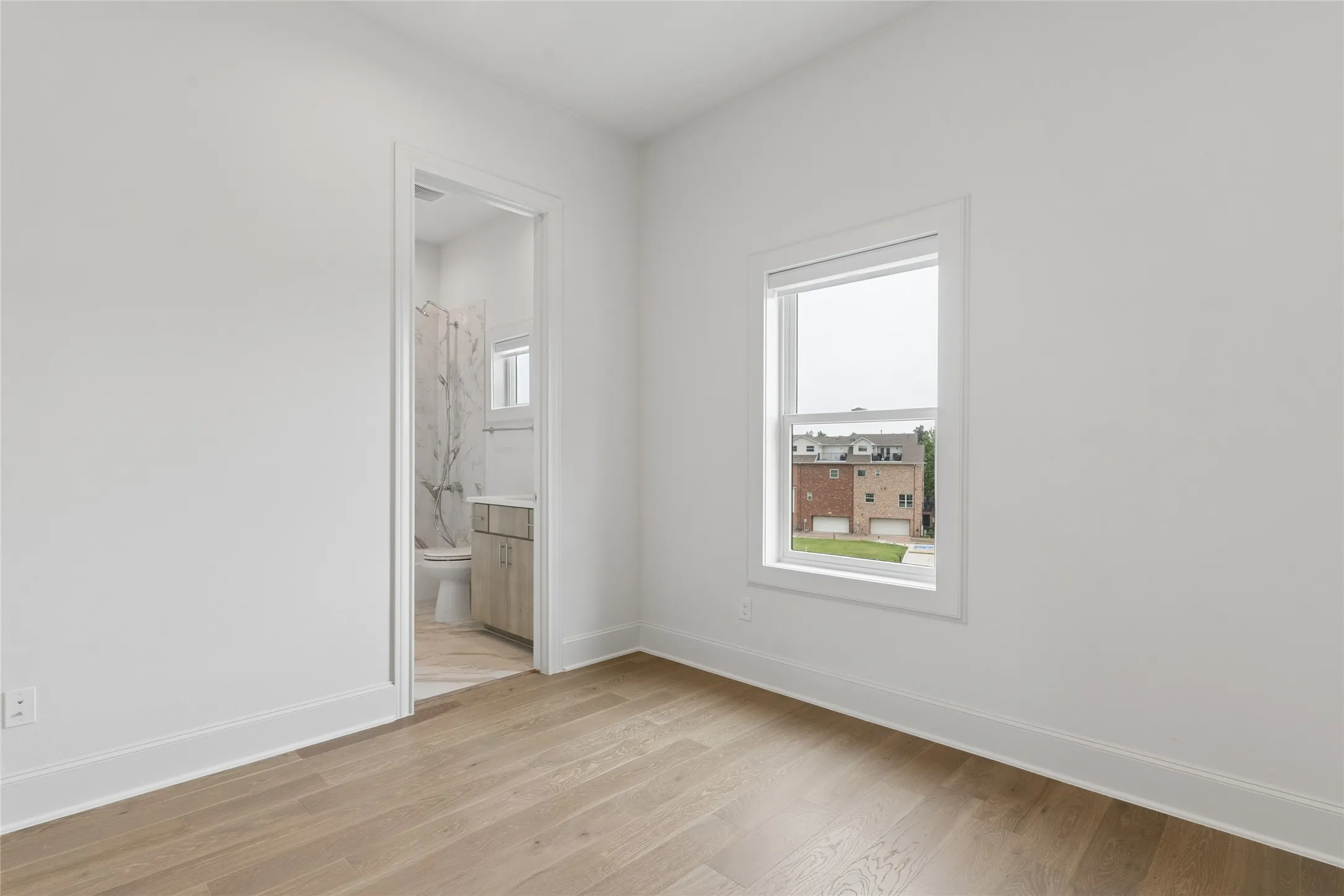 Third floor guest bedroom features an ensuite bathroom. Image of model home with similar layout.