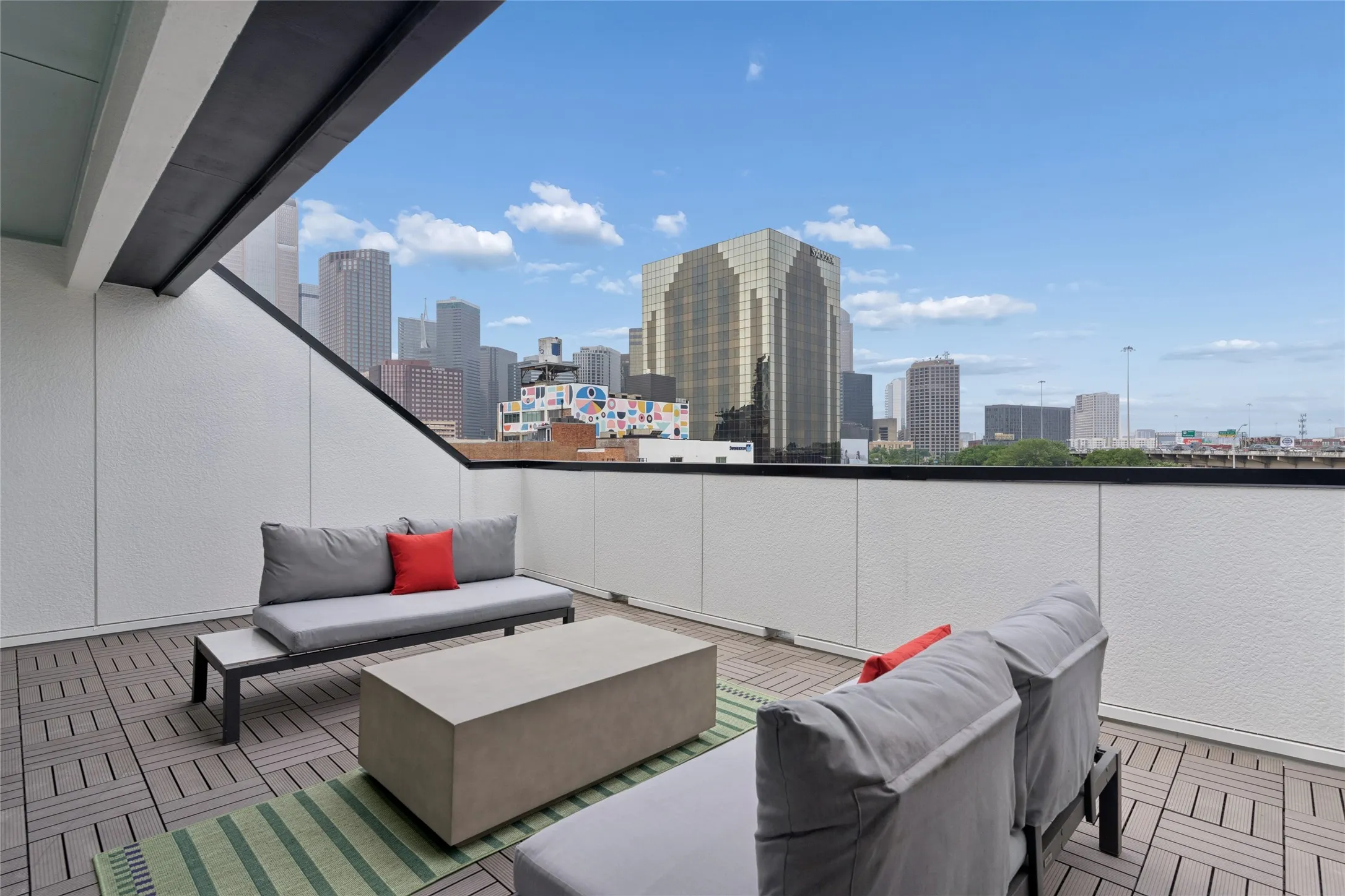 Private roof deck with views of the Dallas skyline. Image of model home with similar layout.