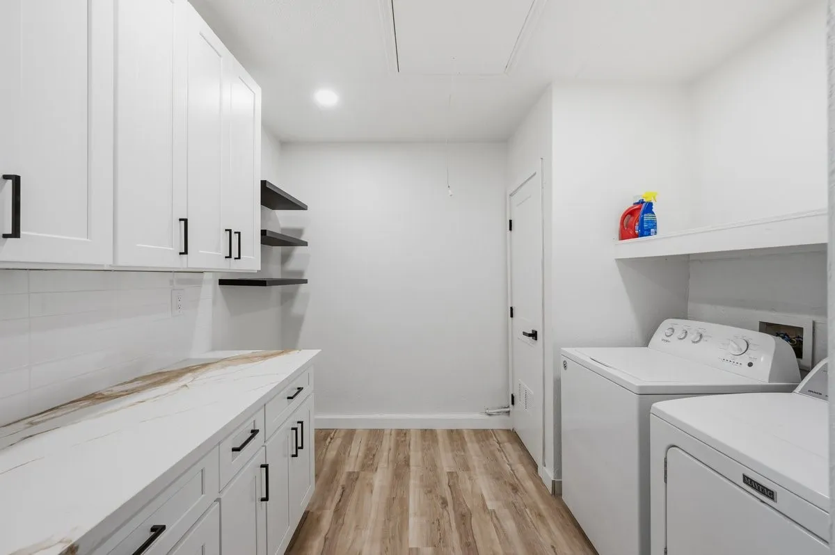 So much storage in this well-appointed laundry room! Pretty quartz countertops.