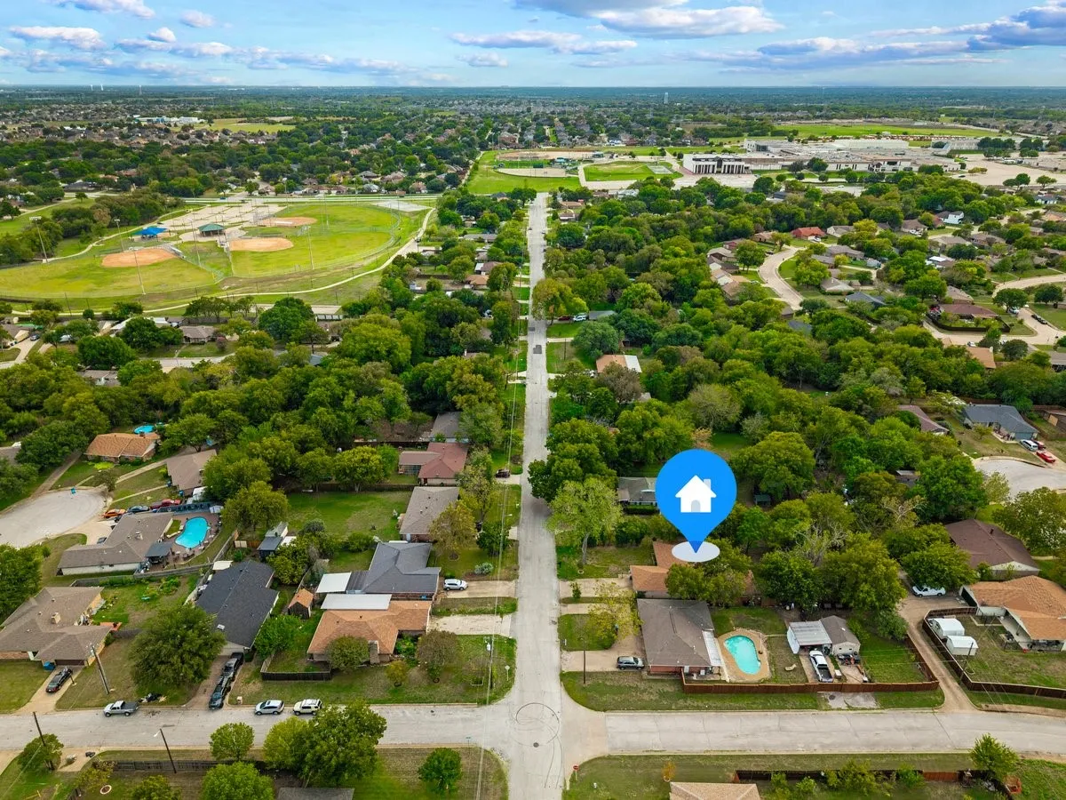 Aerial perspective of property featuring a mature tree canopy, and established neighborhood grounds