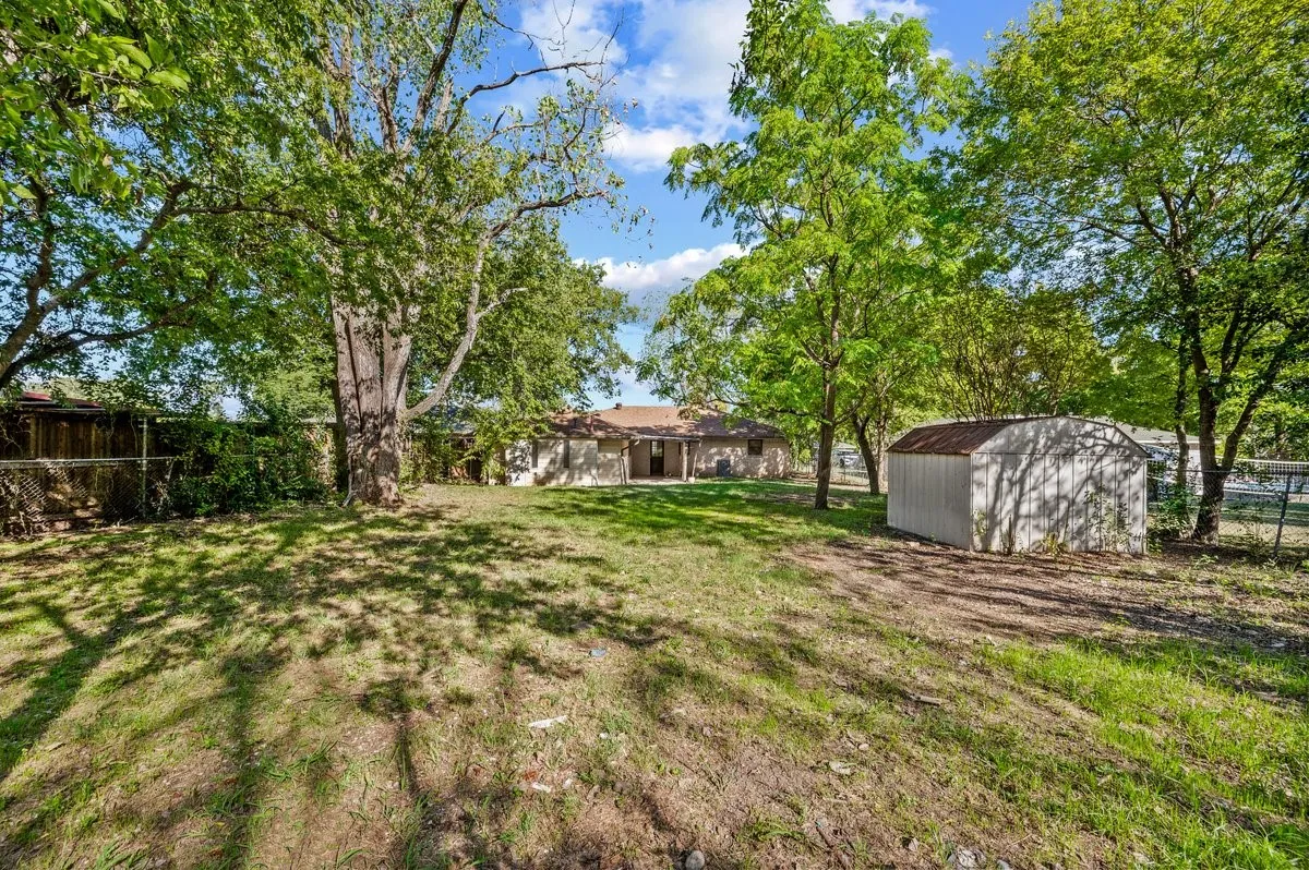 Large backyard with storage shed. Plenty of room for a garden AND for kicking around the soccer ball with the kids!