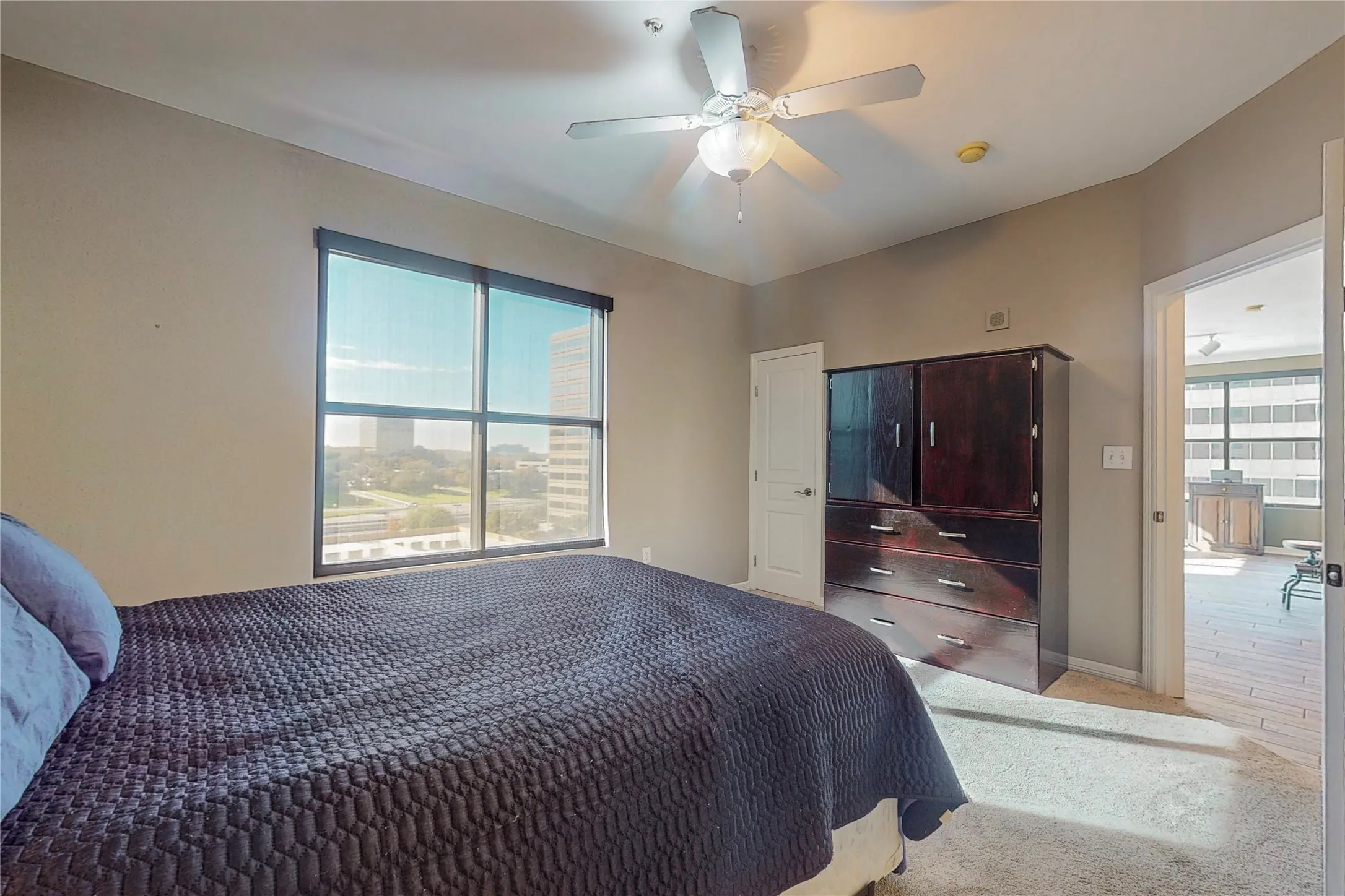 Carpeted bedroom with ceiling fan