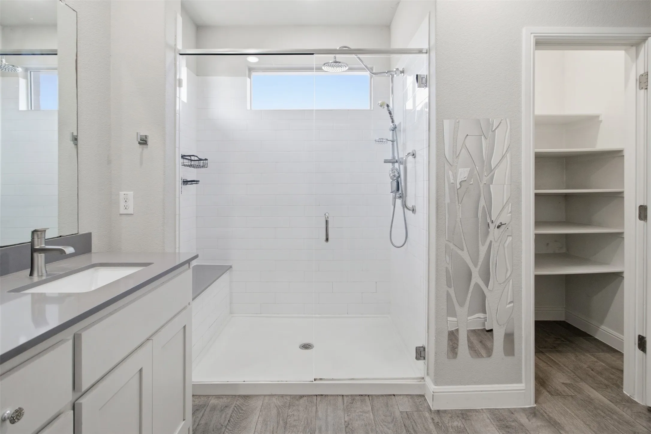Walk-in shower with tiled walls and built-in bench