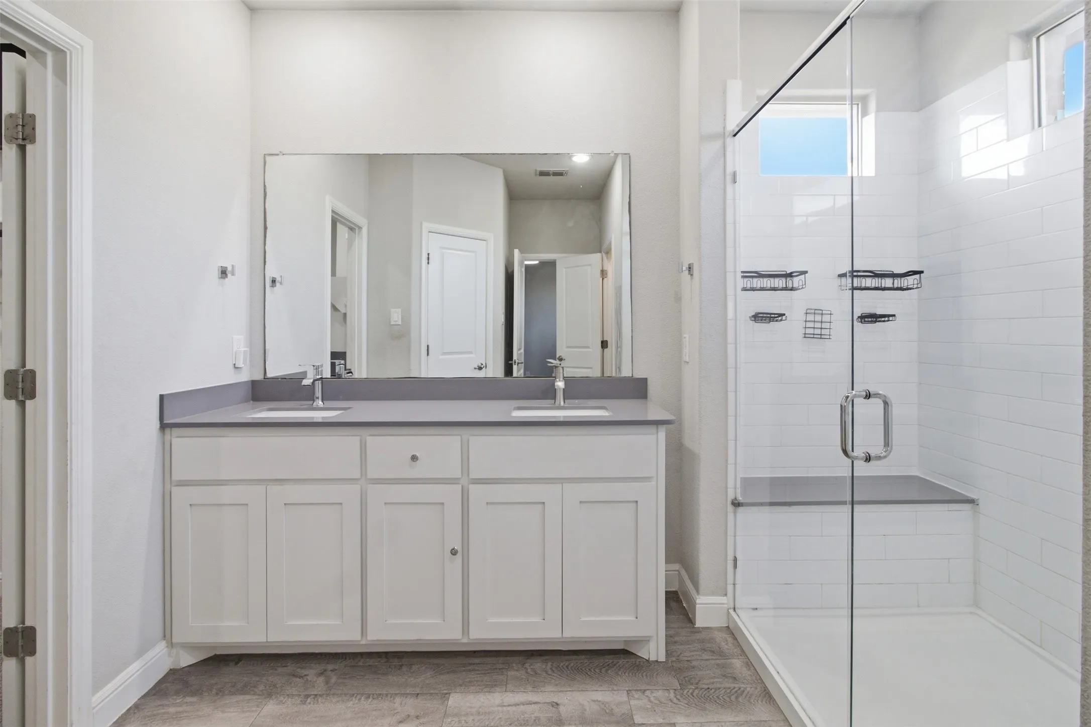 Dual vanity with undermount sinks, gray countertop, and contemporary faucets