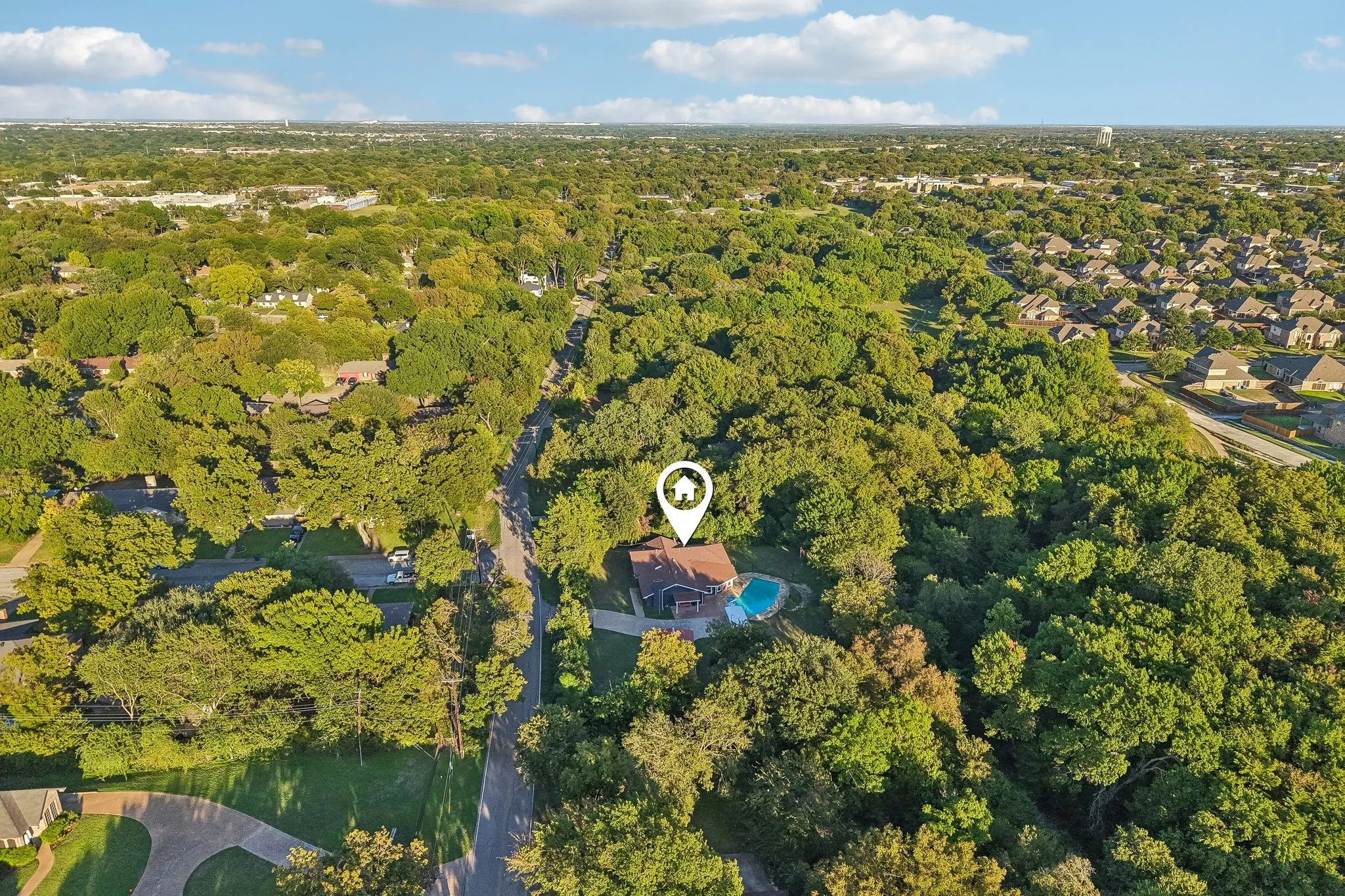 Expansive treed lot featuring a private swimming pool