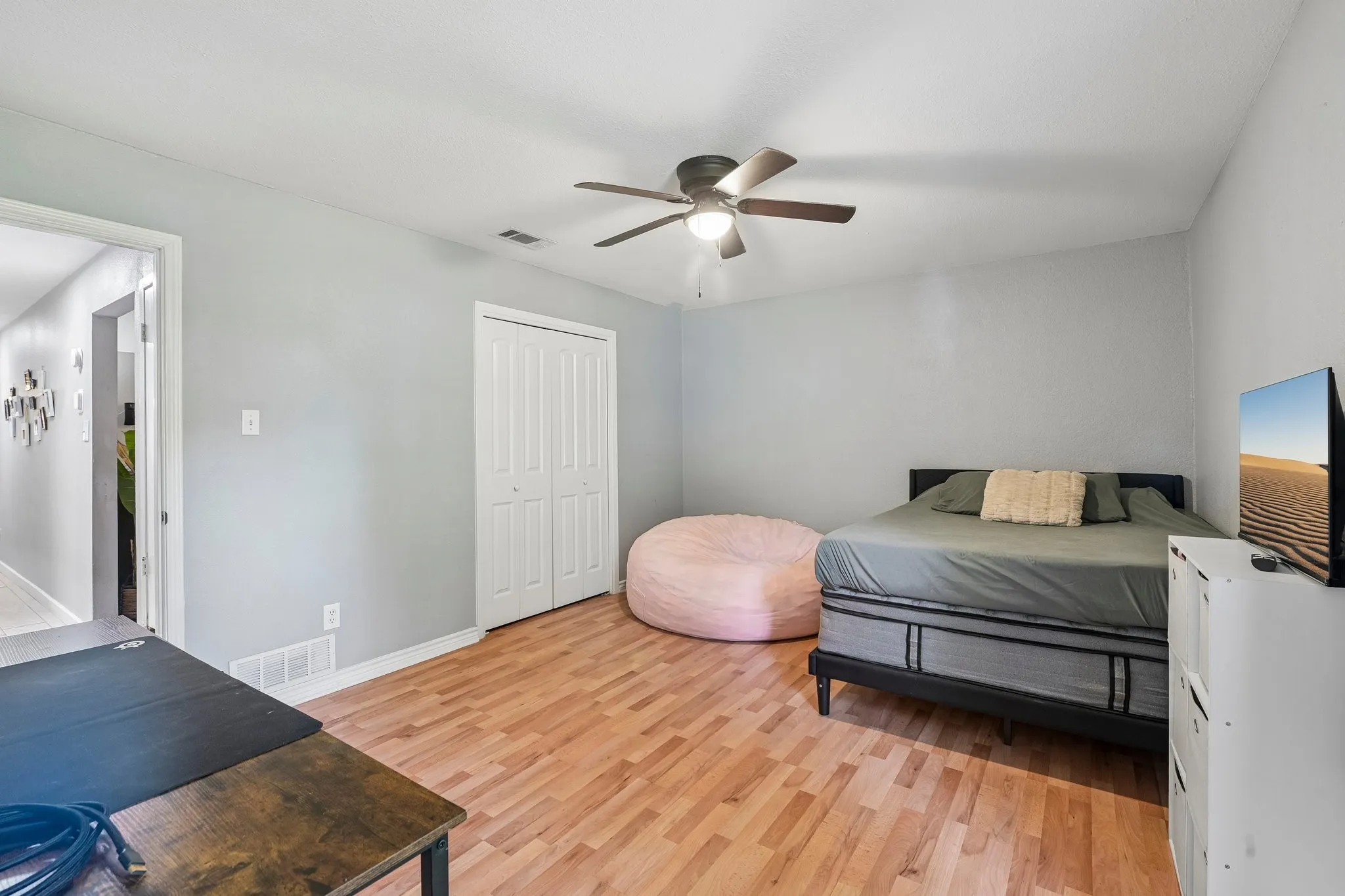 Wood-finish flooring, ceiling fan, and bi-fold closet doors