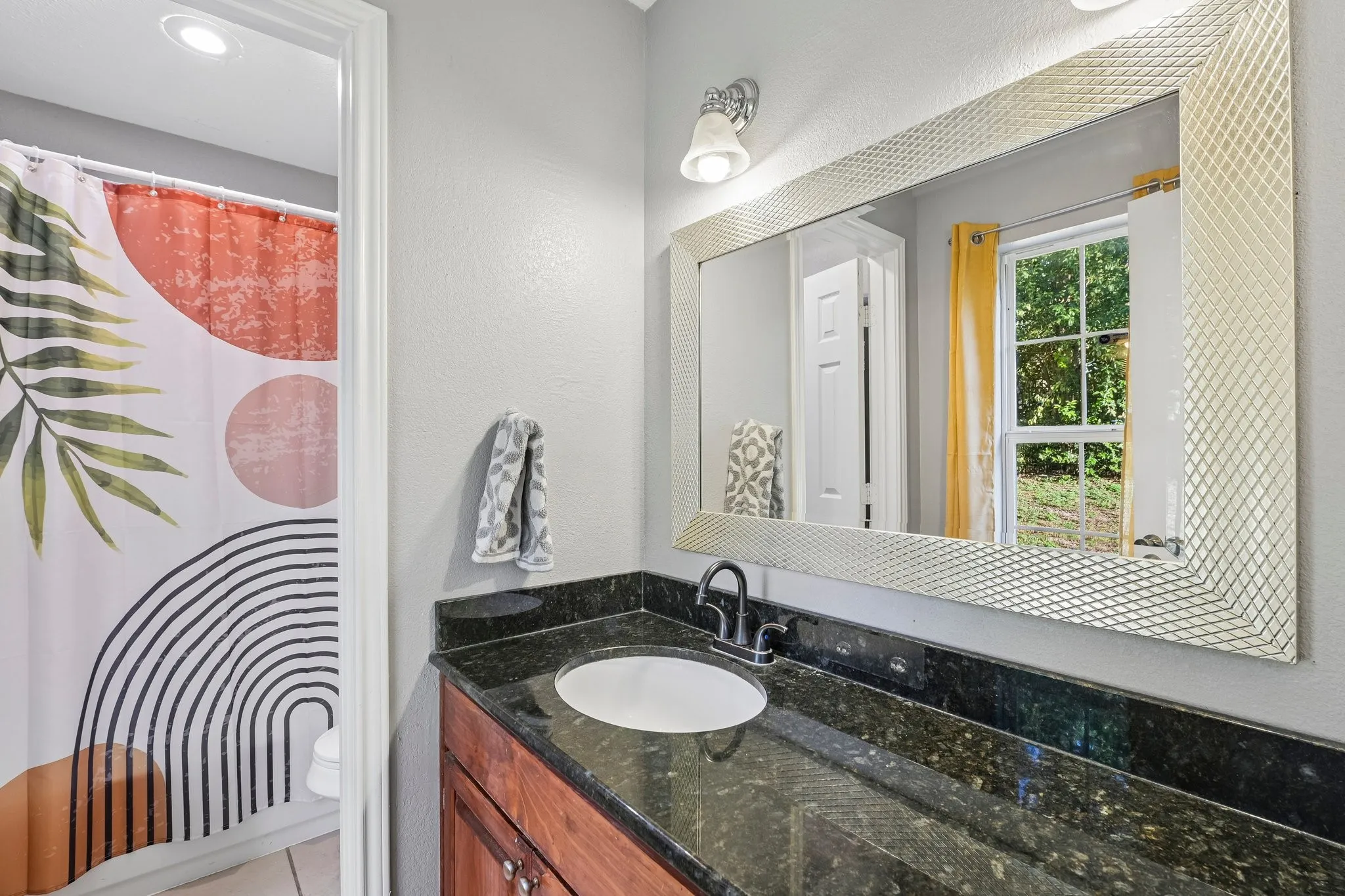Dark-toned countertop with an integrated sink and a single-handle faucet
