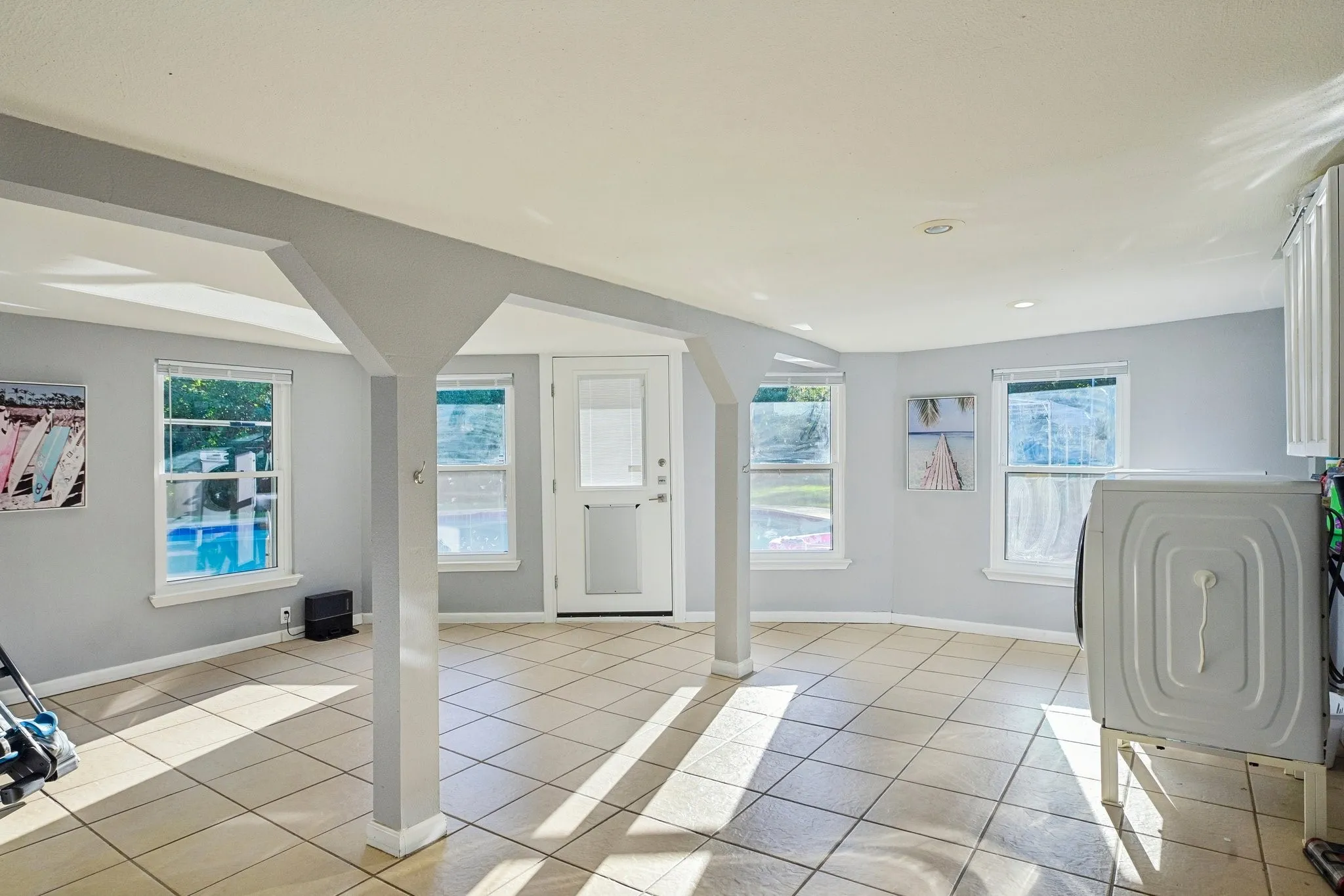 Tile flooring, multiple windows, recessed lighting, and a glass-paneled exterior door
