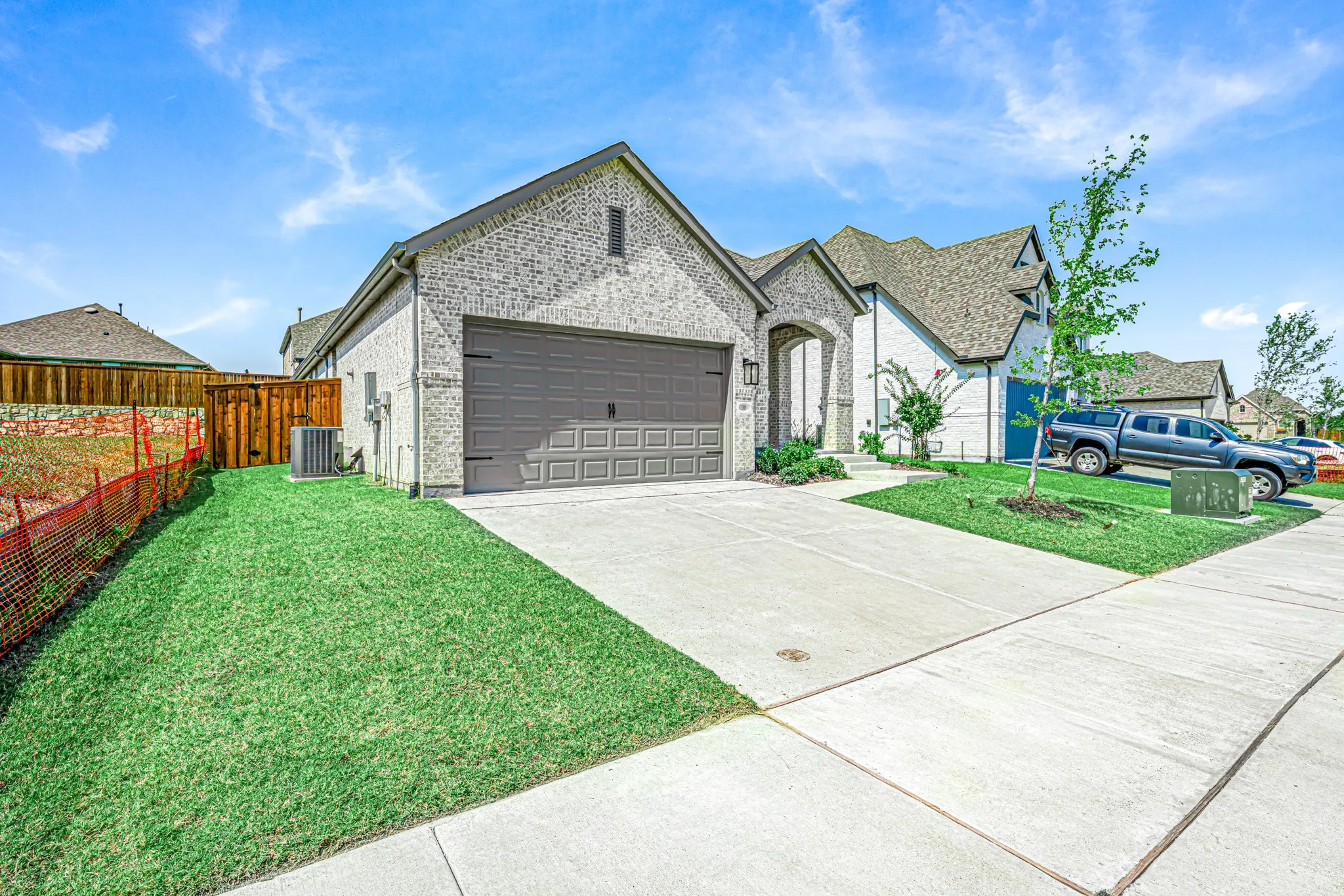 Brick exterior with a stone accent archway, featuring an attached two-car garage