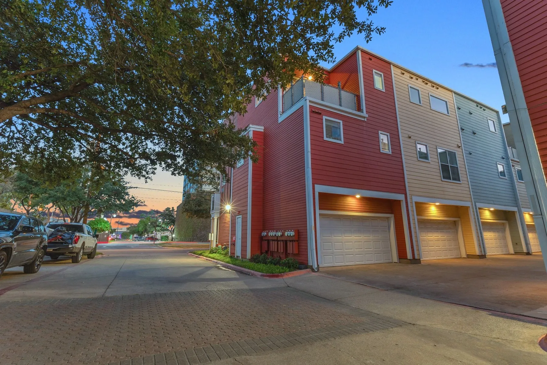 Rear drive with the attached 2-car garage and exterior lighting