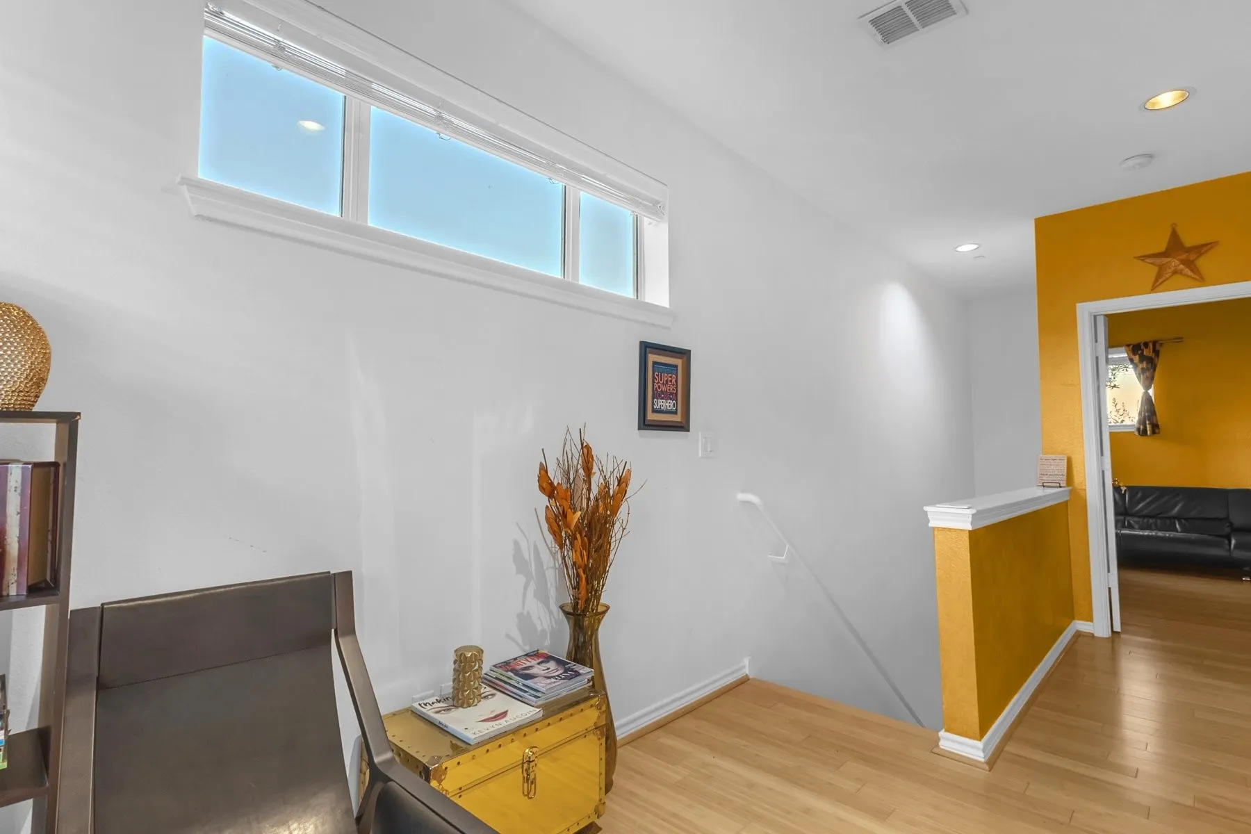 Third-floor landing with clerestory windows and engineered wood floors