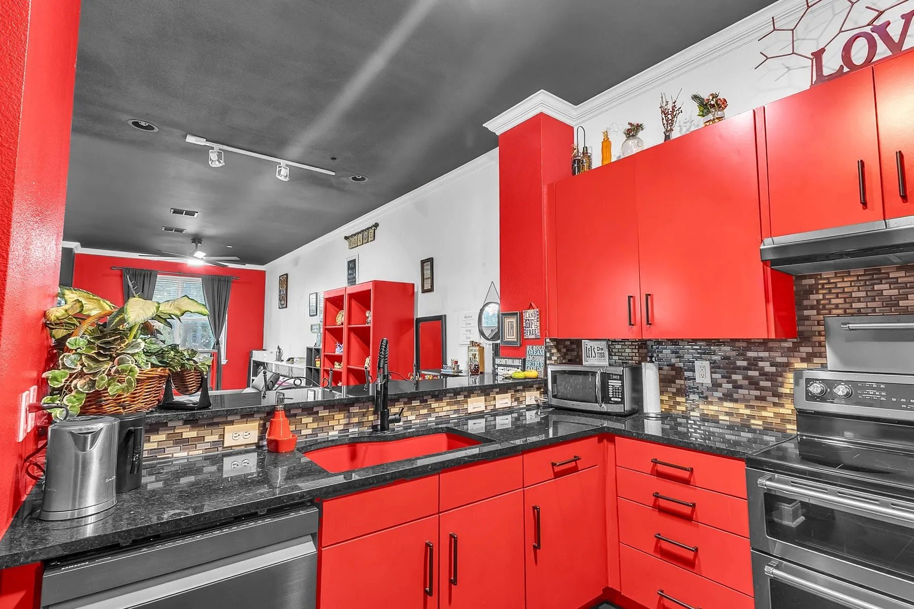 Kitchen with abundant cabinetry, built-in microwave and granite countertops