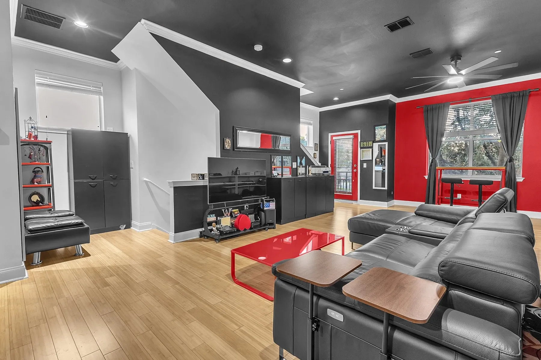 Open second-floor living space with staircase and ceiling fan