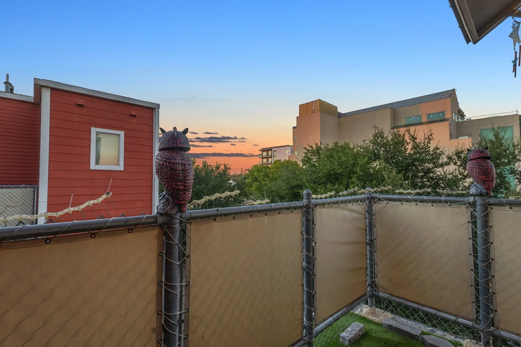 Fenced outdoor terrace with sunset views over the Uptown neighborhood