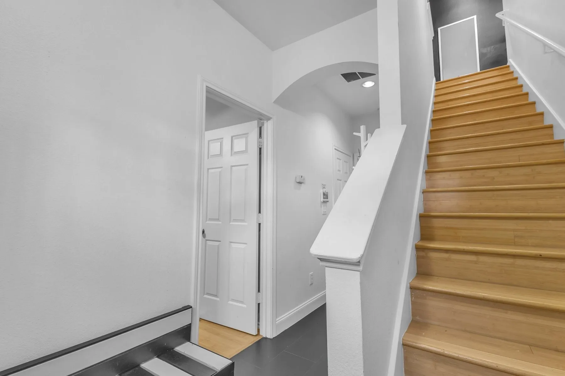 First-floor hall with a engineered wood staircase to the main living level