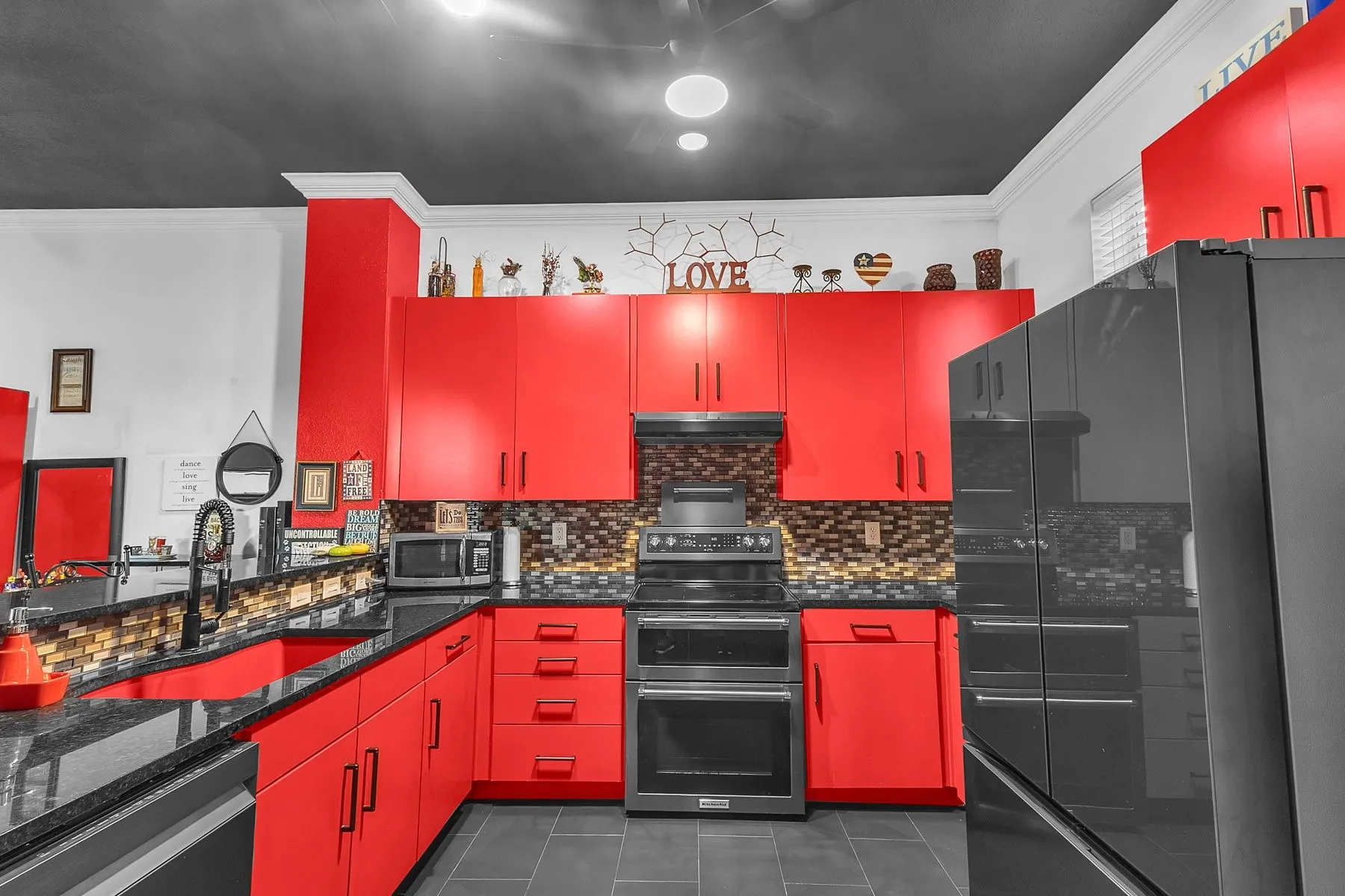U-shaped kitchen with stainless refrigerator, range and full-height upper cabinets
