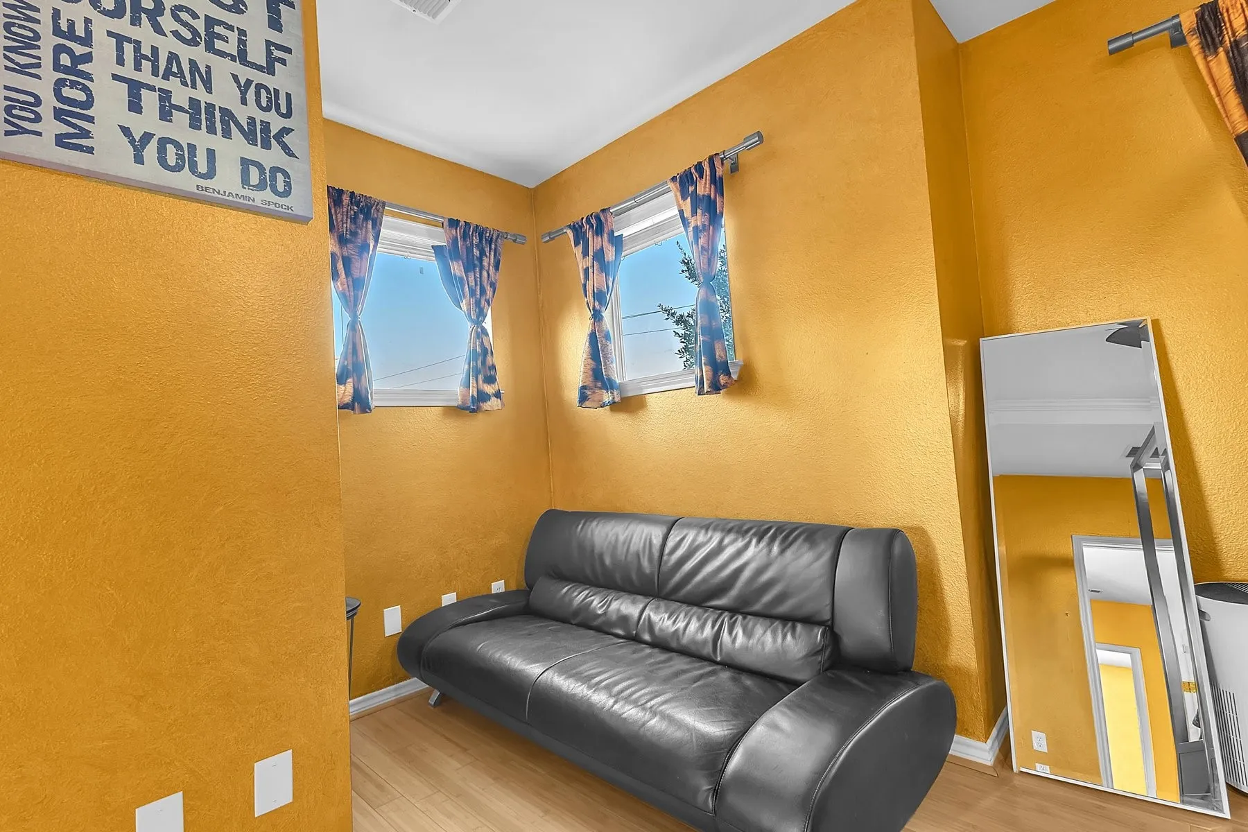 Primary suite sitting area with windows on two sides for natural light