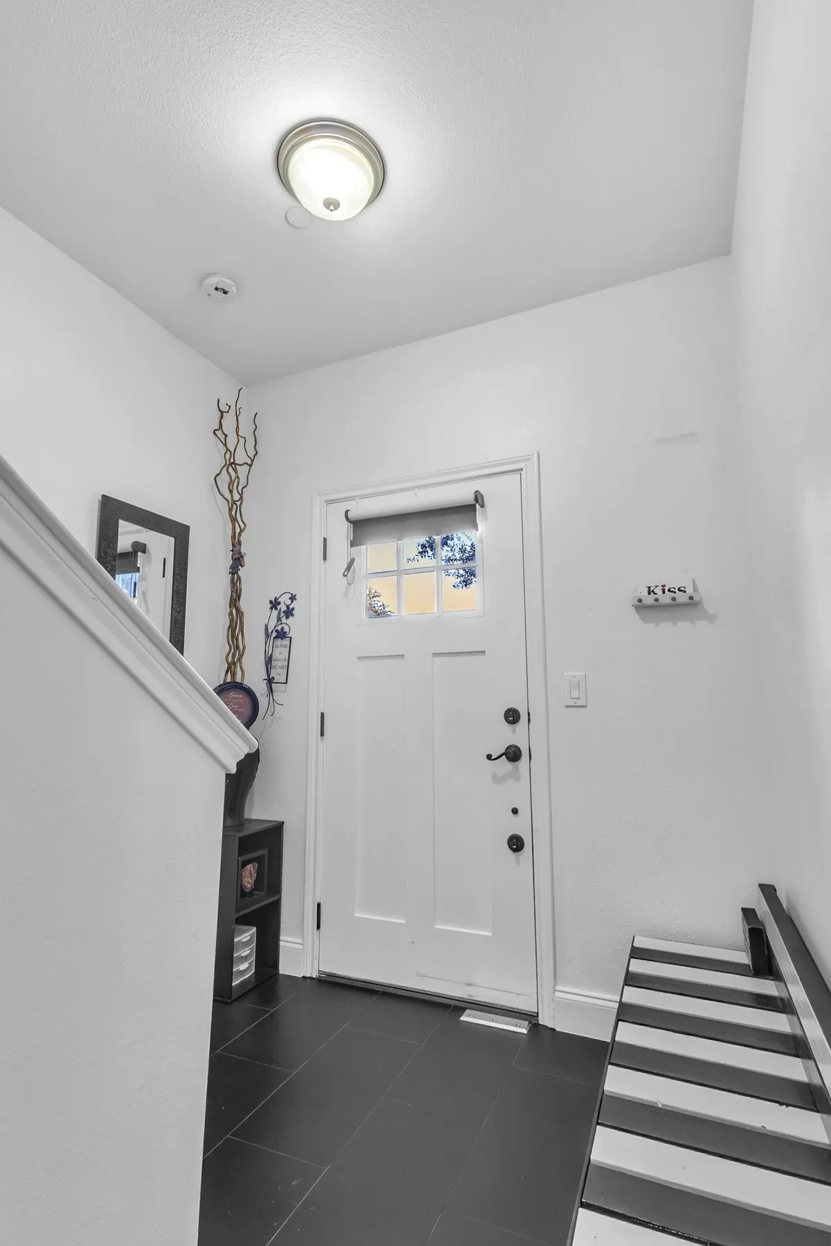 First-floor entry with a tile floor and a door to the front porch