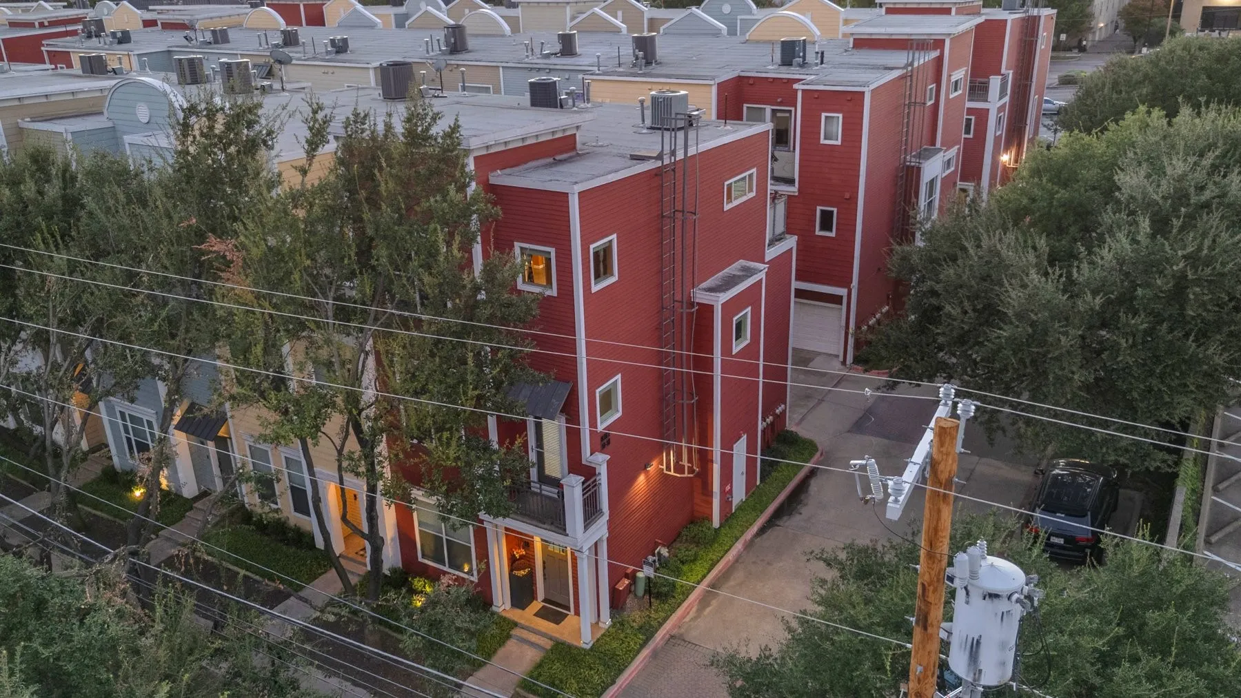 Aerial front view of the end unit with landscaped walkways and trees